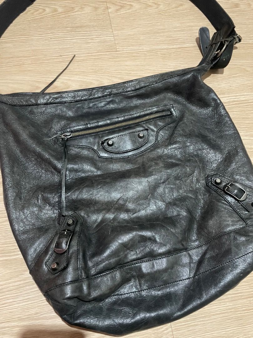 Balenciaga Black Leather Motorcycle Hobo Crossbody Bag (Category: Luxury Bags & Wallets) located in Sorsogon. Submitted by solayram0114595 (Listing ID 1467940407, Image 3). Description: - Brand: Balenciaga - Color: Classic Black - Material: Genuine distressed leather with natural wear - Hardware: Iconic motorcycle metal details and studs - Compartments: Roomy main interior with front zipper pocket - Strap: Adjustable shoulder strap with metal buc