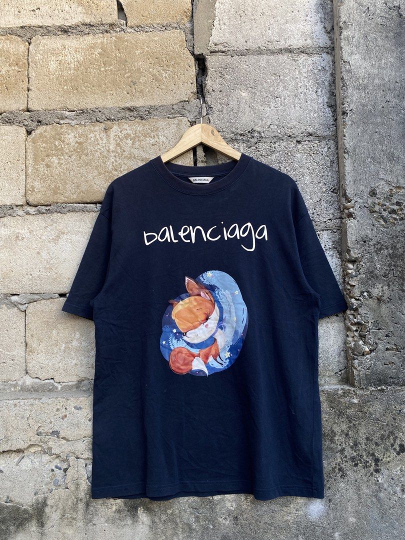 Balenciaga Graphics Tee (Category: Formal Shirts) located in Candaba. Submitted by dejesus.bench17 (Listing ID 1468010863, Image 1). Description: Balenciaga Graphics Fox Tee -Color: Navy Blue -Condition: Excellent -Color rate: 9/10 -Issue: None -Dimes: W21 L28.5 -Price: 599 + ship.