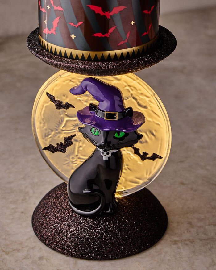 Bath & Body Works Black Cat Light Up Candle Holder (Category: Home Fragrance) located in Quezon City. Submitted by houseoftoni (Listing ID 1467961671, Image 1). Description: - Authentic Bath & Body Works Halloween Candle Holder - Design: Black cat with a purple witch hat in front of a glowing moon backdrop - Details: Features a glittery brown base and top tray - Condition: Brand new with original hang tag (Tag says: "I light up") - Availability: 