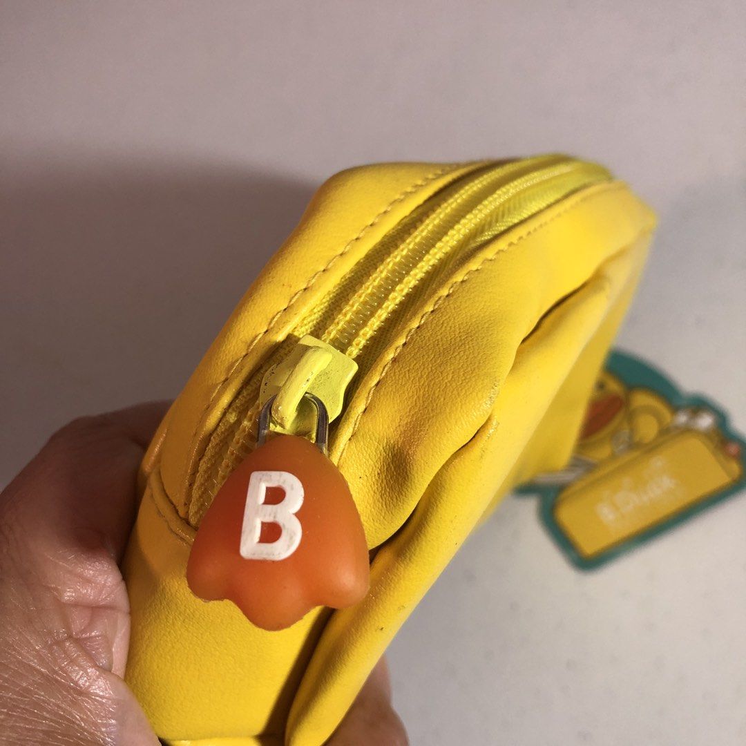 b.duck Yellow Pencil Case with Tag (Category: Stationery & School Supplies) located in Manila. Submitted by all.dressed.up (Listing ID 1467854782, Image 3). Description: Bright yellow B.Duck pencil case Big cute duck face on the front, three little ducks graphic on the side Orange zipper pull with a white B on it Interior has printed school supply patterns like scissors and rulers Still has the original tag attached Roomy and bright Strictly no r