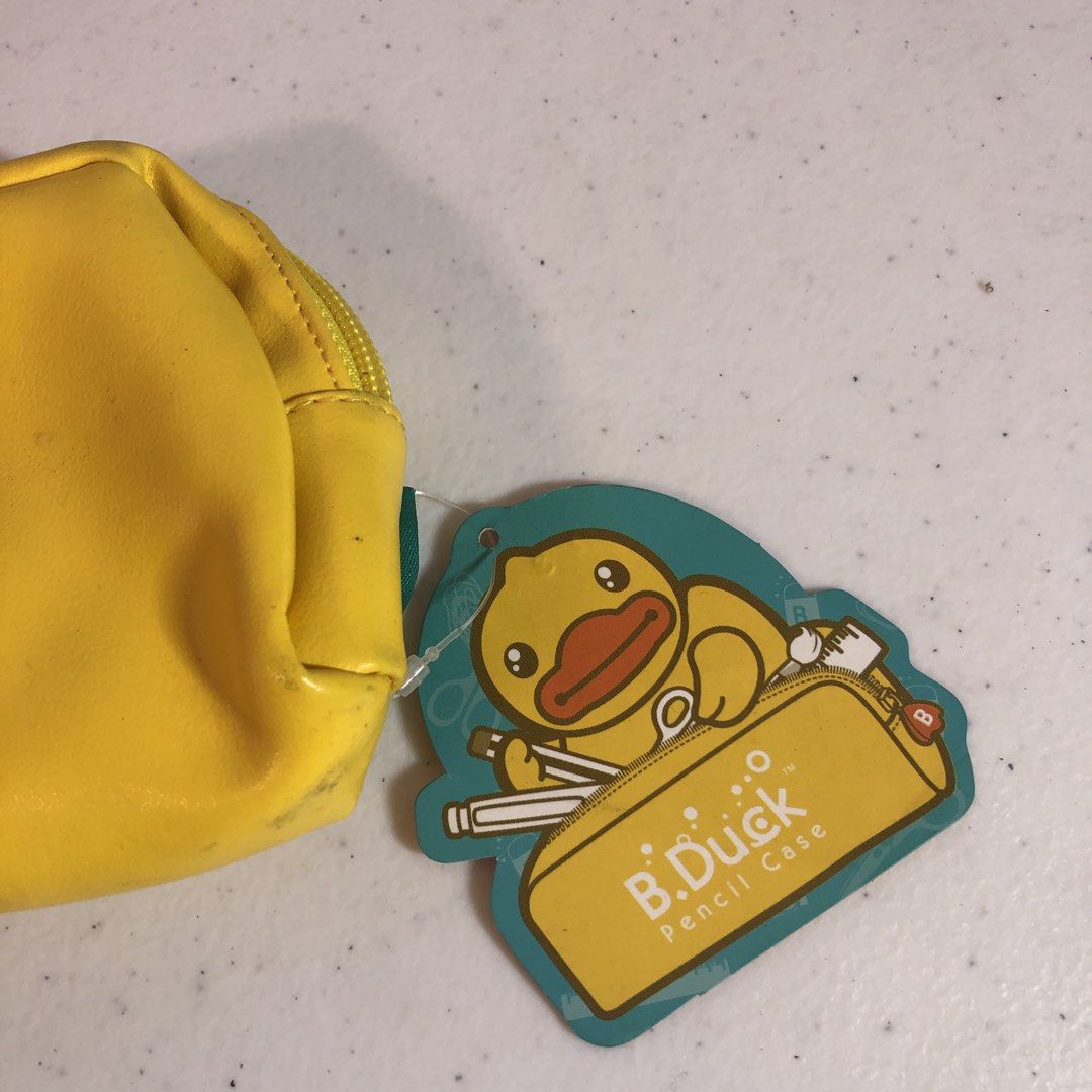 b.duck Yellow Pencil Case with Tag (Category: Stationery & School Supplies) located in Manila. Submitted by all.dressed.up (Listing ID 1467854782, Image 2). Description: Bright yellow B.Duck pencil case Big cute duck face on the front, three little ducks graphic on the side Orange zipper pull with a white B on it Interior has printed school supply patterns like scissors and rulers Still has the original tag attached Roomy and bright Strictly no r