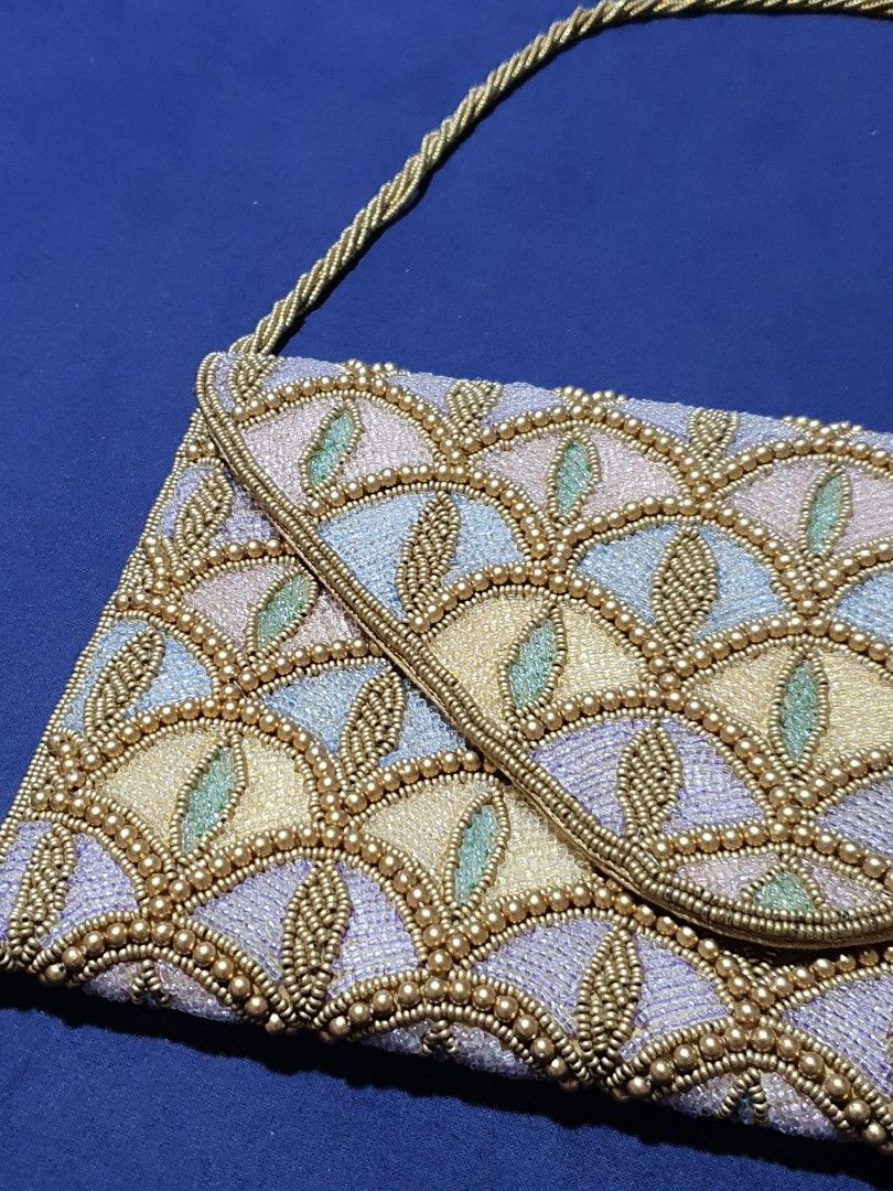 BEADED ART DECO COCKTAIL SHOULDER BAG (Category: Clutches) located in Quezon City. Submitted by carbonfootprint (Listing ID 1467951763, Image 3). Description: UNIQUE and CLASSY Multi-colored beaded pattern with gold bead detailing. Envelope style fold-over flap with a magnetic snap closure. Attached beaded shoulder strap. Measures approximately 11 inches across. Fabric lining inside. Clean beading throughout with no missing stones spotted. BRAND 