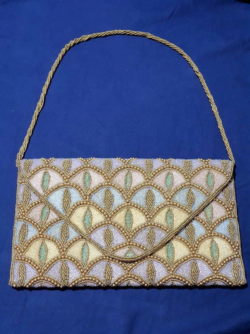 BEADED ART DECO COCKTAIL SHOULDER BAG (Category: Clutches) located in Quezon City. Submitted by carbonfootprint (Listing ID 1467951763, Image 1). Description: UNIQUE and CLASSY Multi-colored beaded pattern with gold bead detailing. Envelope style fold-over flap with a magnetic snap closure. Attached beaded shoulder strap. Measures approximately 11 inches across. Fabric lining inside. Clean beading throughout with no missing stones spotted. BRAND 