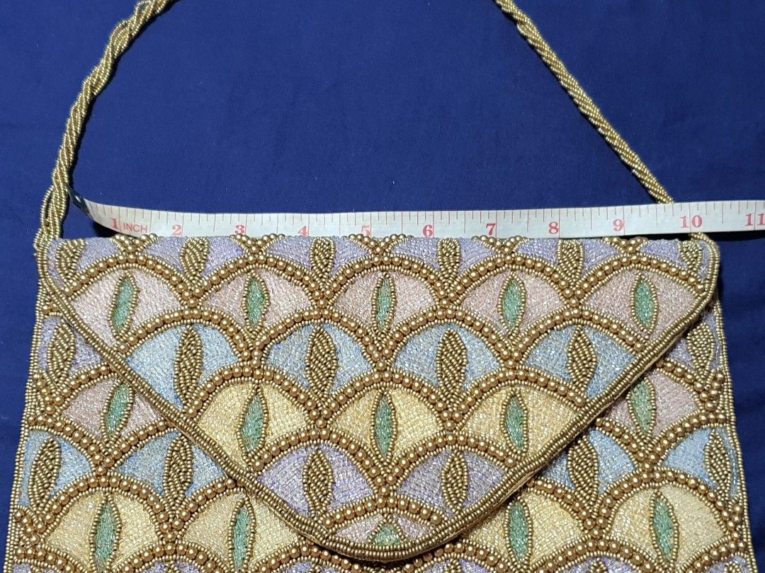 BEADED ART DECO COCKTAIL SHOULDER BAG (Category: Clutches) located in Quezon City. Submitted by carbonfootprint (Listing ID 1467951763, Image 2). Description: UNIQUE and CLASSY Multi-colored beaded pattern with gold bead detailing. Envelope style fold-over flap with a magnetic snap closure. Attached beaded shoulder strap. Measures approximately 11 inches across. Fabric lining inside. Clean beading throughout with no missing stones spotted. BRAND 