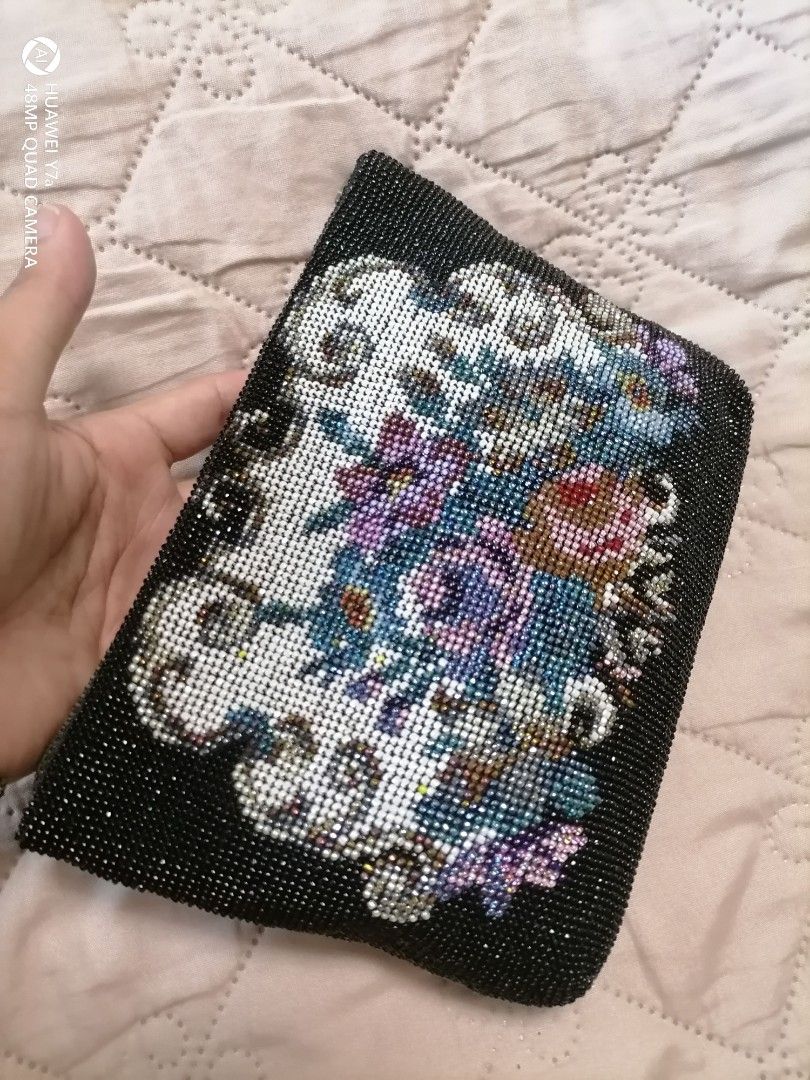 Beaded floral clutch pouch with zip closure (Category: Purses & Pouches) located in Naga. Submitted by mrwisethrifter (Listing ID 1467848654, Image 2). Description: - Beautiful black fabric clutch fully covered in tiny seed beads - Eye-catching colorful floral pattern in purple, blue, pink, and white on the front - Sleek solid black back and sides - Secure top zipper closure with a metal pull - Compact and versatile—ideal as a standalone bag or a