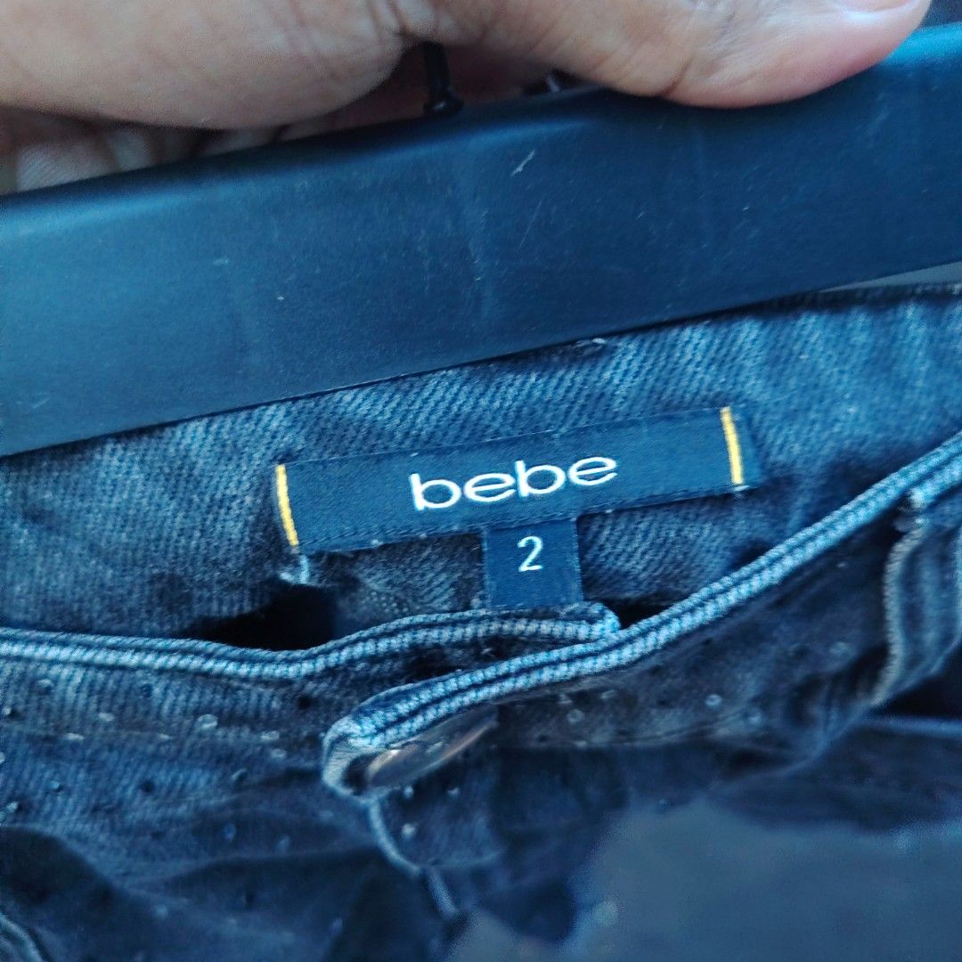 bebe Denim Shorts Black Studded Size 2 (Category: Shorts) located in Manila. Submitted by maetots (Listing ID 1467933208, Image 3). Description: - Brand: bebe - Size: 2 (Article #B24211503) - Color: Black denim - Design: All-over tiny studs with edgy raw frayed hems - Fit: Mid-rise with practical front flap pockets - Hardware: Branded silver accents - Material: 80% cotton, 20% polyester, with trace amounts of viscose - Origin: Made in China.