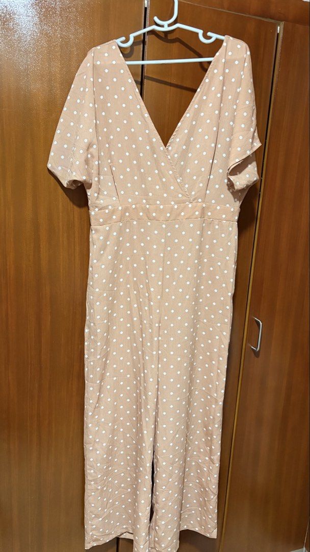 Beige Polka Dot V-Neck Jumpsuit (Category: Jumpsuits) located in Taytay. Submitted by sparklesandhighheels (Listing ID 1467885519, Image 1). Description: - Color & Pattern: Classic beige with all-over white polka dots - Design: V-neck wrap style with short sleeves and a defined waist seam - Cut: Relaxed straight-leg pants - Material: Lightweight, breathable, and comfortable for everyday wear - Perfect for: Casual outings, brunch dates, or running