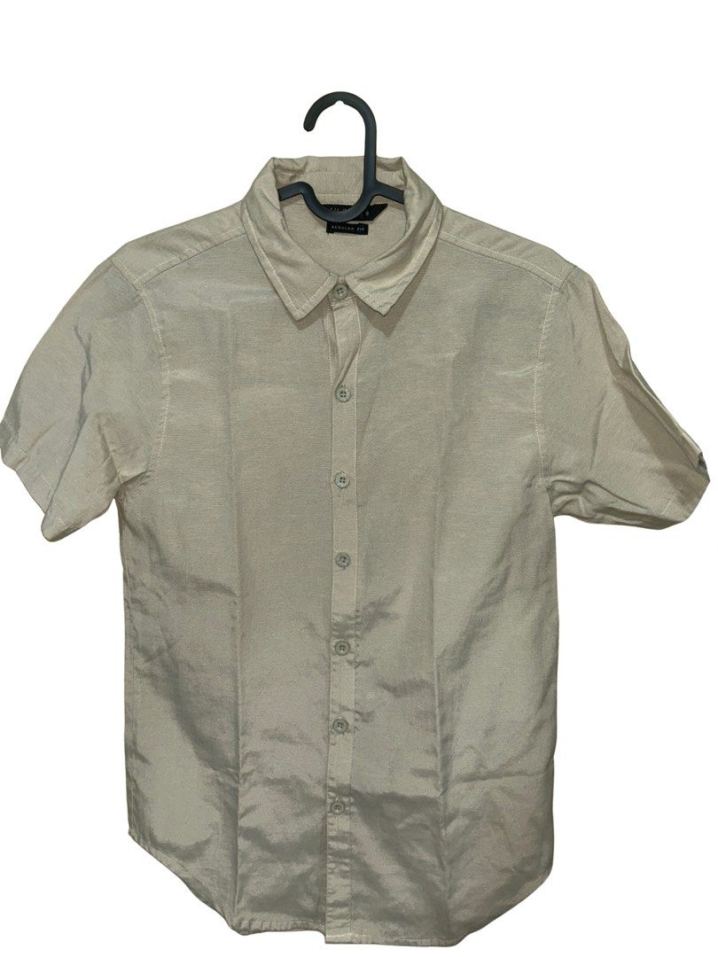 Beige short sleeve button-up shirt (Category: Formal Shirts) located in Manila. Submitted by engrjoshag30609 (Listing ID 1467993448, Image 1). Description: - Color: Neutral beige - Fit: Regular fit with standard collar and front button placket - Material: Lightweight and comfortable - Style: Ideal for casual outings or smart-casual office wear - Condition: Clean, well-maintained.