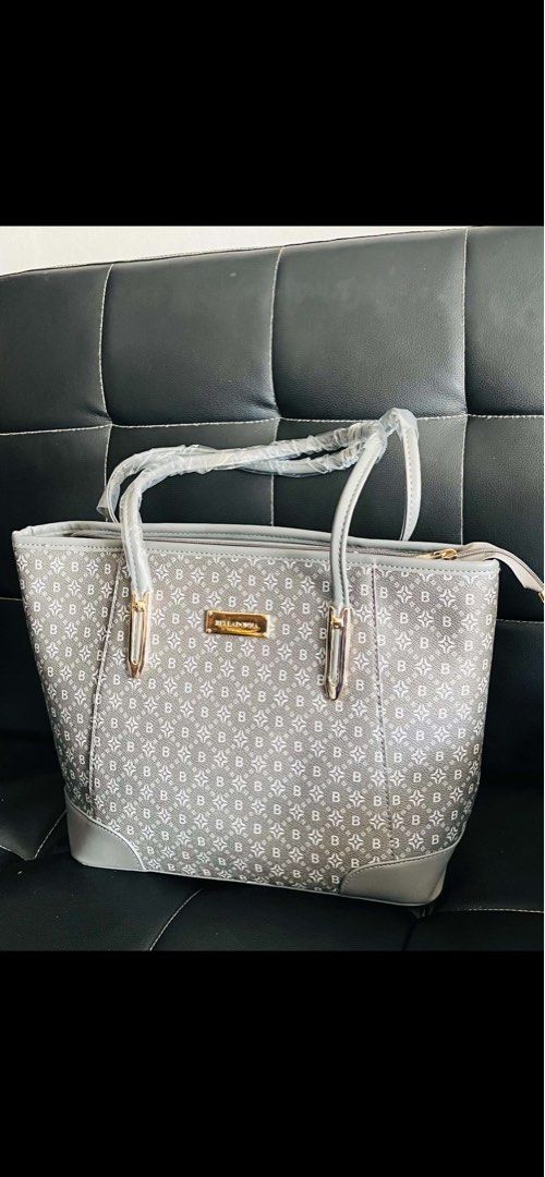 Belladonna Grey Monogram Tote Bag (Category: Tote Bags) located in Malolos. Submitted by magnoannchrstn (Listing ID 1467932015, Image 1). Description: - Brand: Belladonna - Style: Tote bag in stylish grey monogram print - Details: Solid grey trim, gold-tone hardware with front branded plaque, and pink side tag - Handles: Double top handles with protective plastic wrap still intact - Pockets: Rear exterior zip pocket for quick access - Closure: Se