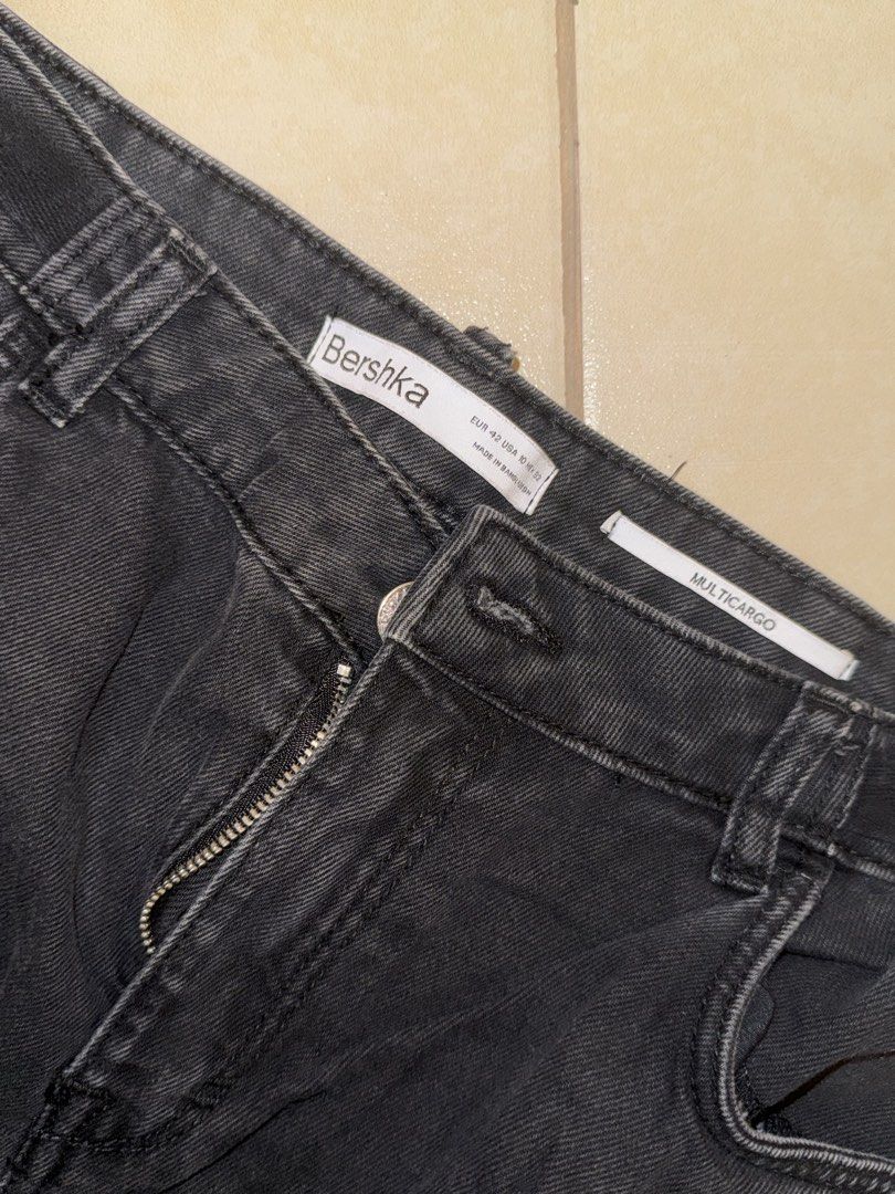 Bershka Multicargo Black Jeans (Category: Jeans) located in Makati City. Submitted by cooldragon_2d8241 (Listing ID 1467993248, Image 2). Description: - Brand: Bershka - Style: Multicargo denim jeans in washed black - Size: EUR 42 / USA 10 / MEX 32 - Fit: Mid-rise with zip fly and button closure - Details: Multiple utility pockets on legs and sides, heavy denim material - Vibe: Perfect for streetwear looks .