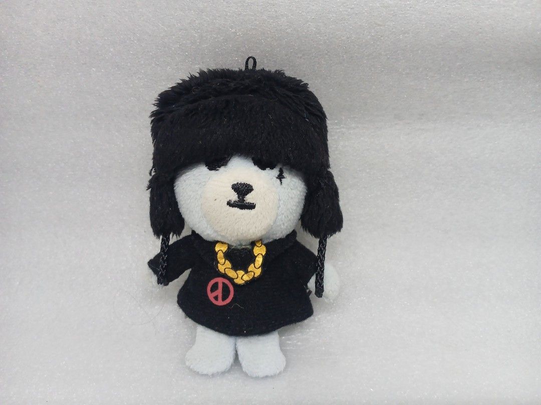 BIGBANG Krunk Plush Keychain (Category: Plushies & Soft Toys) located in Pila. Submitted by Yela.ph_1 (Listing ID 1467945967, Image 2). Description: - Official YG Entertainment merchandise - BIGBANG Krunk plush keychain - Wears a black ushanka hat, matching black outfit, gold chain, and pink peace symbol shirt - White bear body with official YG tag on the back - Great accessory for hanging on bags or keys.