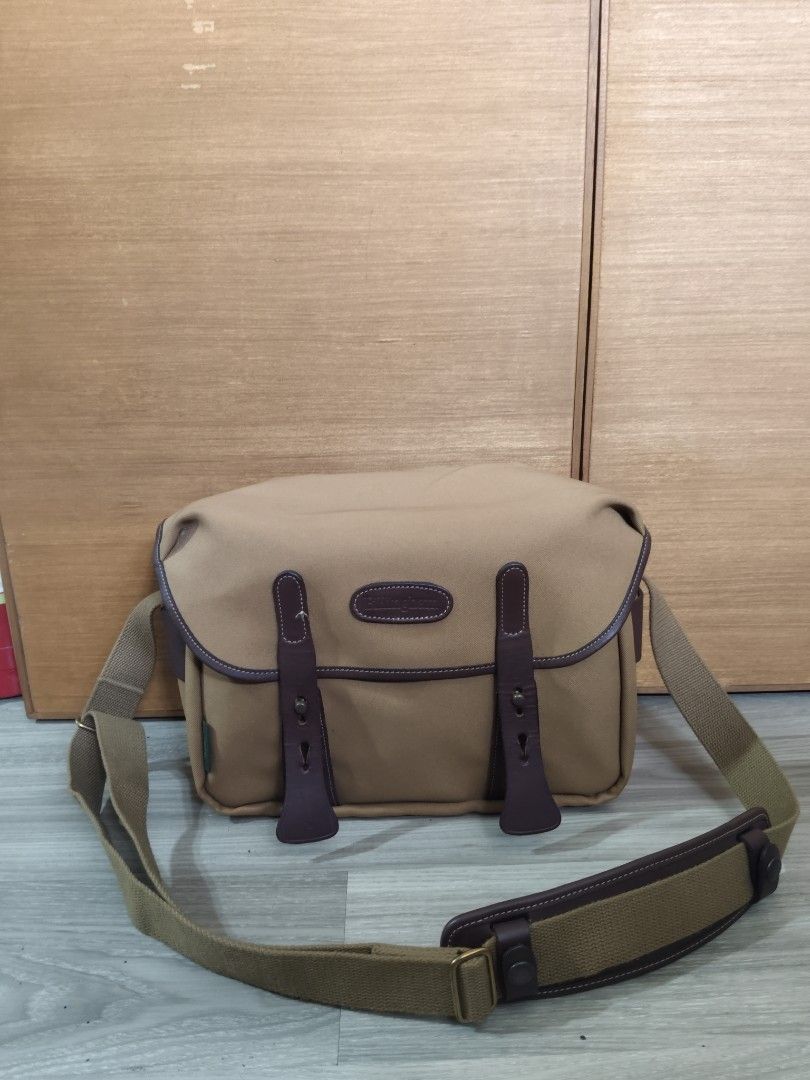 Billingham Camera Bag Khaki Tan (Category: Camera Bags & Carriers) located in San Mateo. Submitted by roxyj120919 (Listing ID 1467894825, Image 1). Description: - Authentic Billingham camera bag in classic khaki and brown leather - Handcrafted in England showcasing premium British quality - - Generous main compartment with customizable padded interior dividers - Durable canvas shoulder strap complete with a comfortable leather shoulder pad - Secu