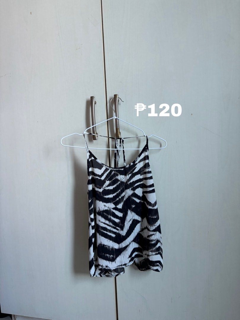 Black and white zebra print spaghetti strap top (Category: Sleeveless) located in Sariaya. Submitted by starstore.ph (Listing ID 1467889069, Image 1). Description: mop: gcash/maribank mod: jnt/lalamove/grab/meetup (mandaluyong or makati only) - Trendy black and white zebra print - Sleeveless design with thin spaghetti straps - Chic crisscross back detail - Lightweight and loose-fitting fabric - Versatile for casual outings or layering.