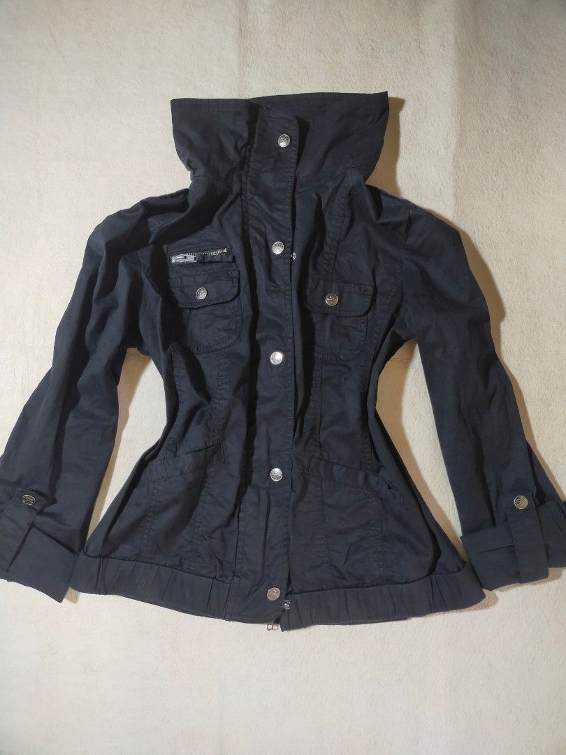 Black Casual Utility Jacket with Pockets (Category: Coats, Jackets and Outerwear) located in Santo Tomas. Submitted by zenzenzennaya (Listing ID 1467991584, Image 1). Description: - Color: Black - Material: Sturdy cotton blend, perfect for cool weather - Design: High collar with front snap buttons - Pockets: Multiple chest pockets including a secure zippered compartment - Sleeves: Roll-up feature with button tabs - Fit: Elasticated hem and cuffs 