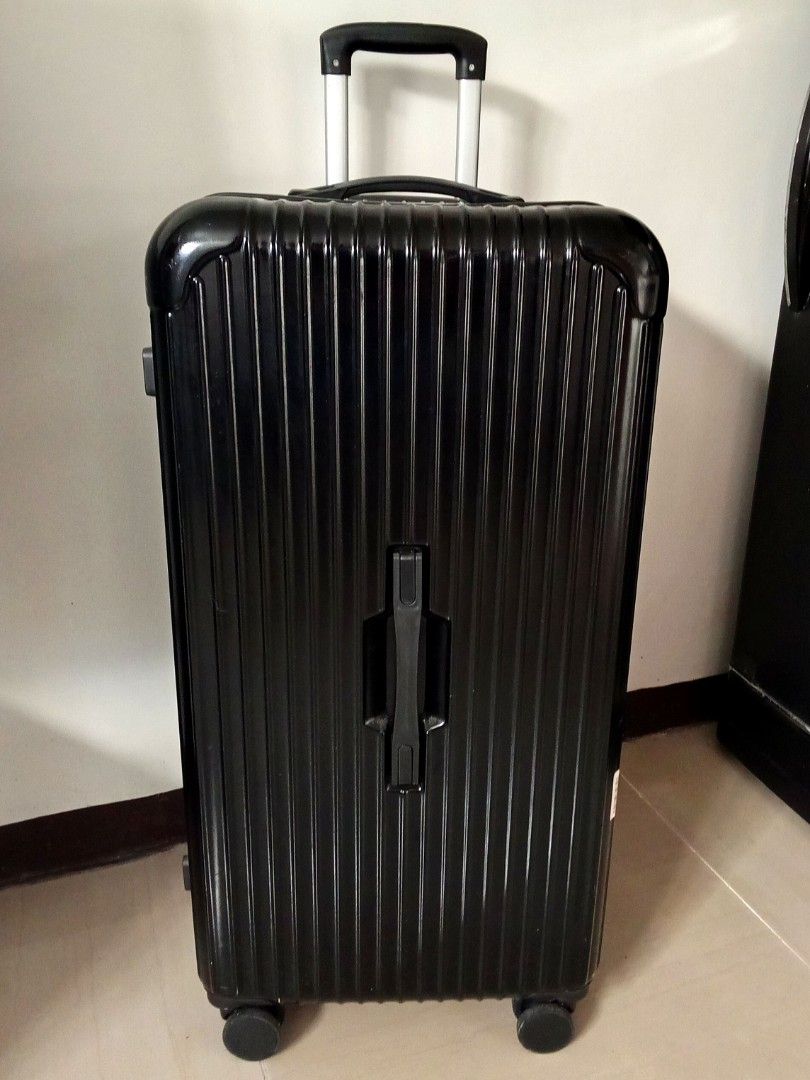 Black Hard Shell Suitcase with Retractable Handle (Category: Luggage) located in Quezon City. Submitted by santos2016 (Listing ID 1467919377, Image 1). Description: - Durable black hard shell luggage with a stylish vertical ribbed design - Features a retractable telescoping handle, top carry handle, and a convenient front grab handle - Smooth-rolling wheels for easy maneuverability - Spacious main compartment to fit all your travel essentials - E