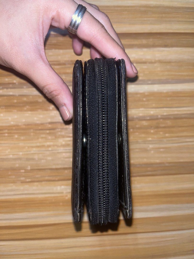 Black leather zip-around folding wallet with card slots (Category: Wallets & Card holders) located in Naic. Submitted by nasaryn_ (Listing ID 1468000083, Image 2). Description: - Color: Classic Black - Material: Leather - Design: Compact folding wallet with secure snap buttons - Storage: Multiple card slots and a zipped central coin compartment - Condition: Pre-owned with outer signs of use; inner compartments are 100% functional - Perfect for ev