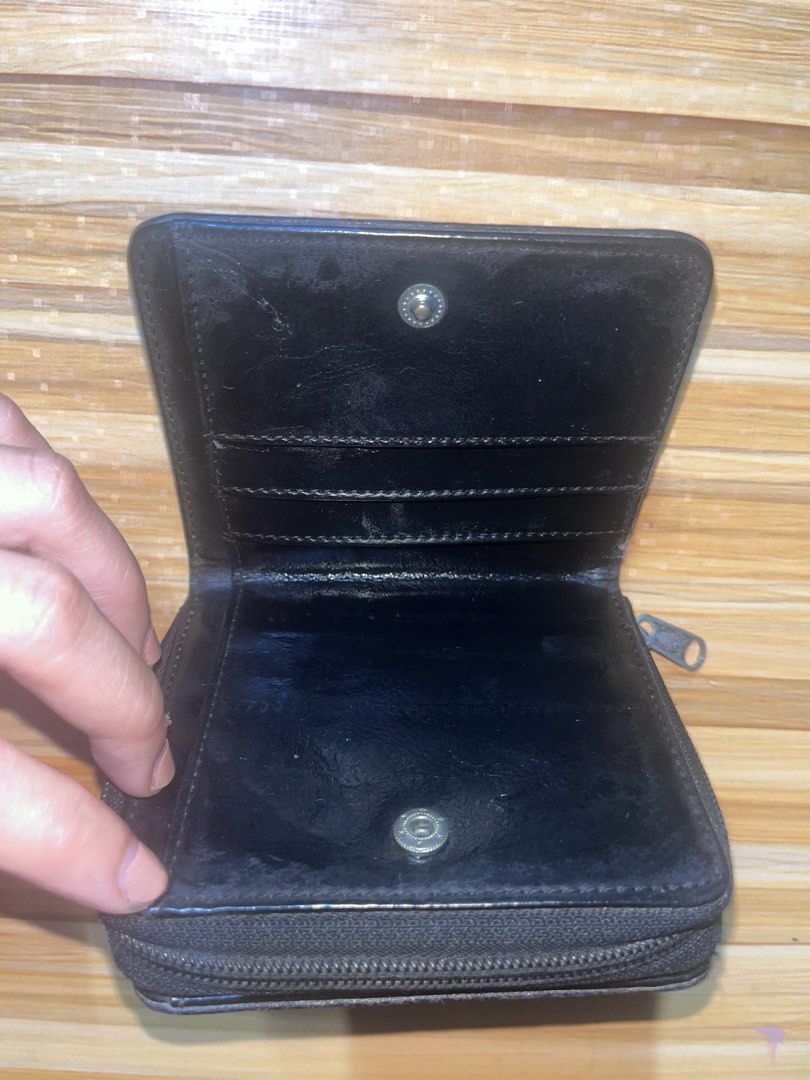 Black leather zip-around folding wallet with card slots (Category: Wallets & Card holders) located in Naic. Submitted by nasaryn_ (Listing ID 1468000083, Image 3). Description: - Color: Classic Black - Material: Leather - Design: Compact folding wallet with secure snap buttons - Storage: Multiple card slots and a zipped central coin compartment - Condition: Pre-owned with outer signs of use; inner compartments are 100% functional - Perfect for ev
