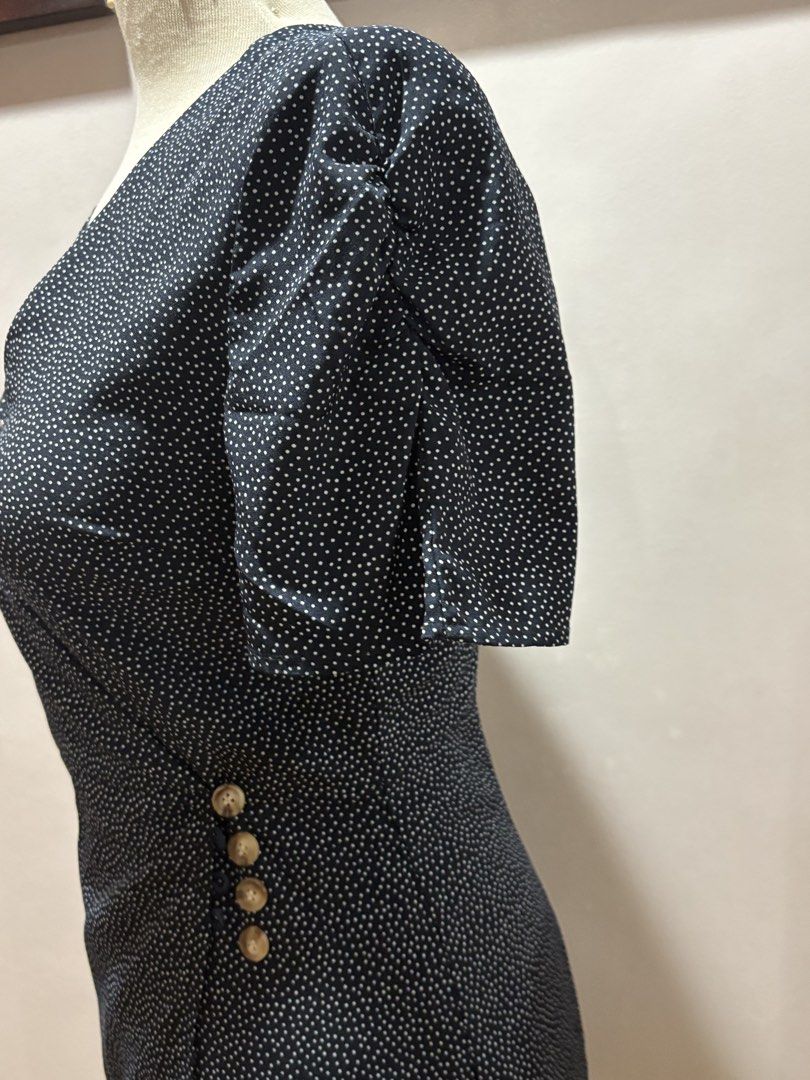 Black Polka Dot Wrap Dress Size Medium (Category: Dresses) located in Cavite. Submitted by momskiette (Listing ID 1467938665, Image 3). Description: - Color & Pattern: Classic black with tiny white polka dots - Style: V-neck wrap design with short sleeves and a fitted silhouette hitting around the knee - Details: Four chic decorative gold-toned buttons on the left waist - Size: Medium Waist : 28-29 in chest: 36.
