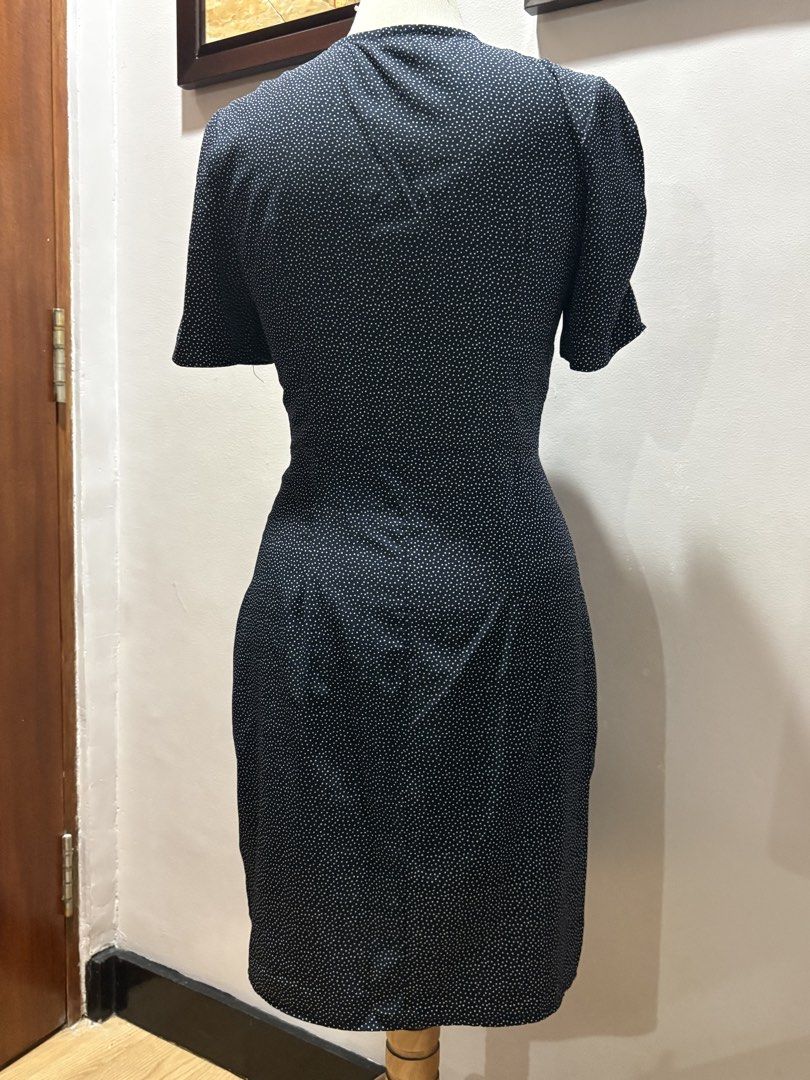 Black Polka Dot Wrap Dress Size Medium (Category: Dresses) located in Cavite. Submitted by momskiette (Listing ID 1467938665, Image 2). Description: - Color & Pattern: Classic black with tiny white polka dots - Style: V-neck wrap design with short sleeves and a fitted silhouette hitting around the knee - Details: Four chic decorative gold-toned buttons on the left waist - Size: Medium Waist : 28-29 in chest: 36.