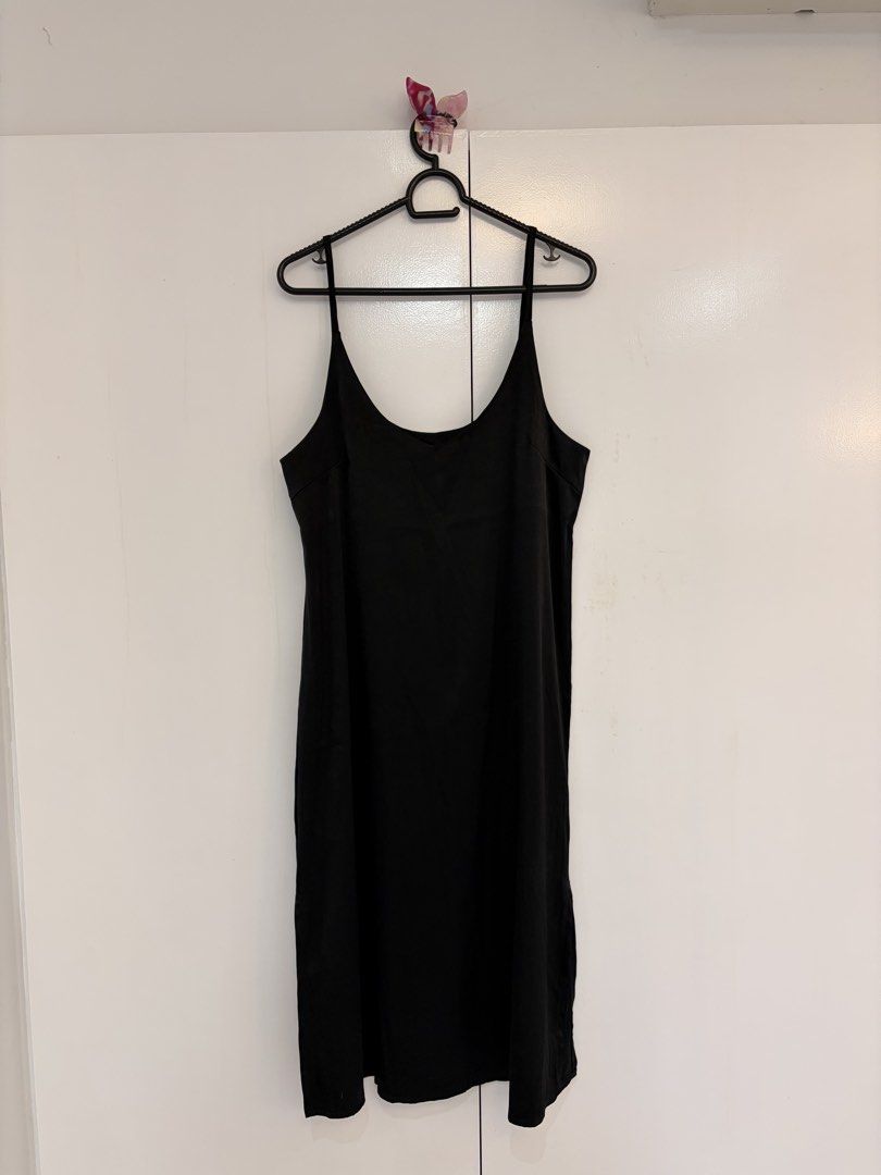 Black Slip Midi Dress (Category: Dresses) located in Quezon City. Submitted by prelovedbynxkole (Listing ID 1467880394, Image 1). Description: - Color: Classic black - Style: Simple midi dress with spaghetti straps - Fit: Comfortable relaxed fit with a flattering drape - Versatility: Effortless to dress up or down for day or night - Condition: Great wardrobe staple - Fits M to L ALL CLOTHES NEED TO BE WASHED & IRONED AS THEY HAVE BEEN SITTING IN 