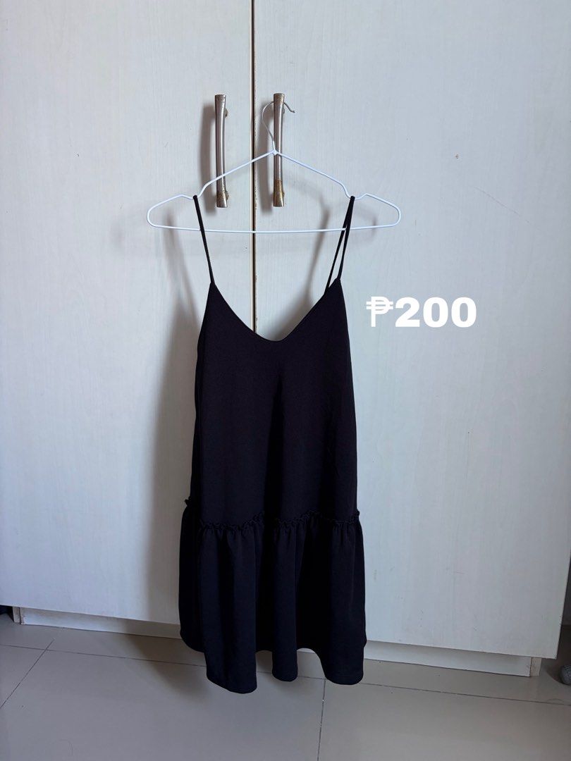 Black Spaghetti Strap Ruffle Hem Dress (Category: Dresses) located in Sariaya. Submitted by starstore.ph (Listing ID 1467889339, Image 1). Description: mop: gcash/maribank mod: jnt/lalamove/grab/meetup (mandaluyong or makati only) - Color: Classic black - Design: Thin straps with a cute ruffled drop-waist hem - Fit: Flared cut, length hits comfortably above the knee - Fabric: Lightweight and easy to pack for trips - Styling: Great staple piece fo
