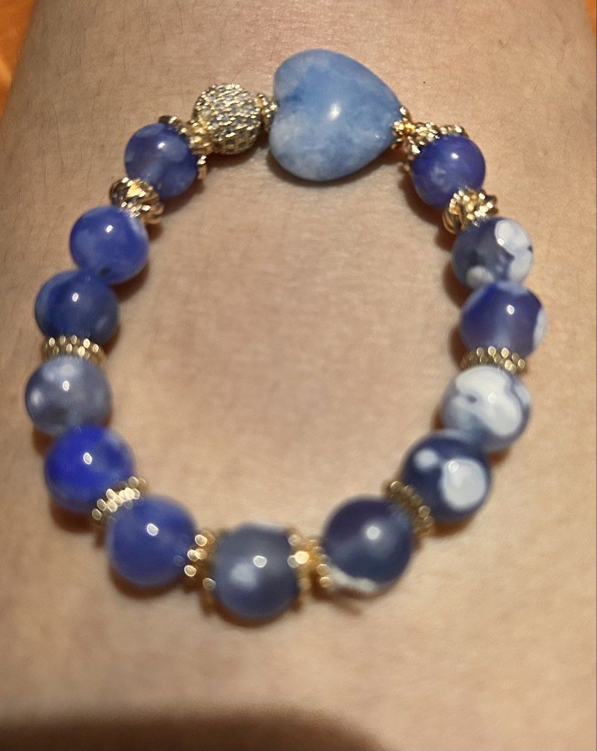 Blue Agate Bead Bracelet With Heart Pendant (Category: Bracelets) located in Marikina City. Submitted by tresariascats (Listing ID 1467914219, Image 1). Description: - Gorgeous blue beaded bracelet - Made with natural agate beads and gold spacers - Features a light blue carved heart pendant and a sparkly rhinestone ball accent - Stretchy elastic band fits most wrist sizes - Perfect for everyday wear or stacking with other jewelry - Well-kept cond