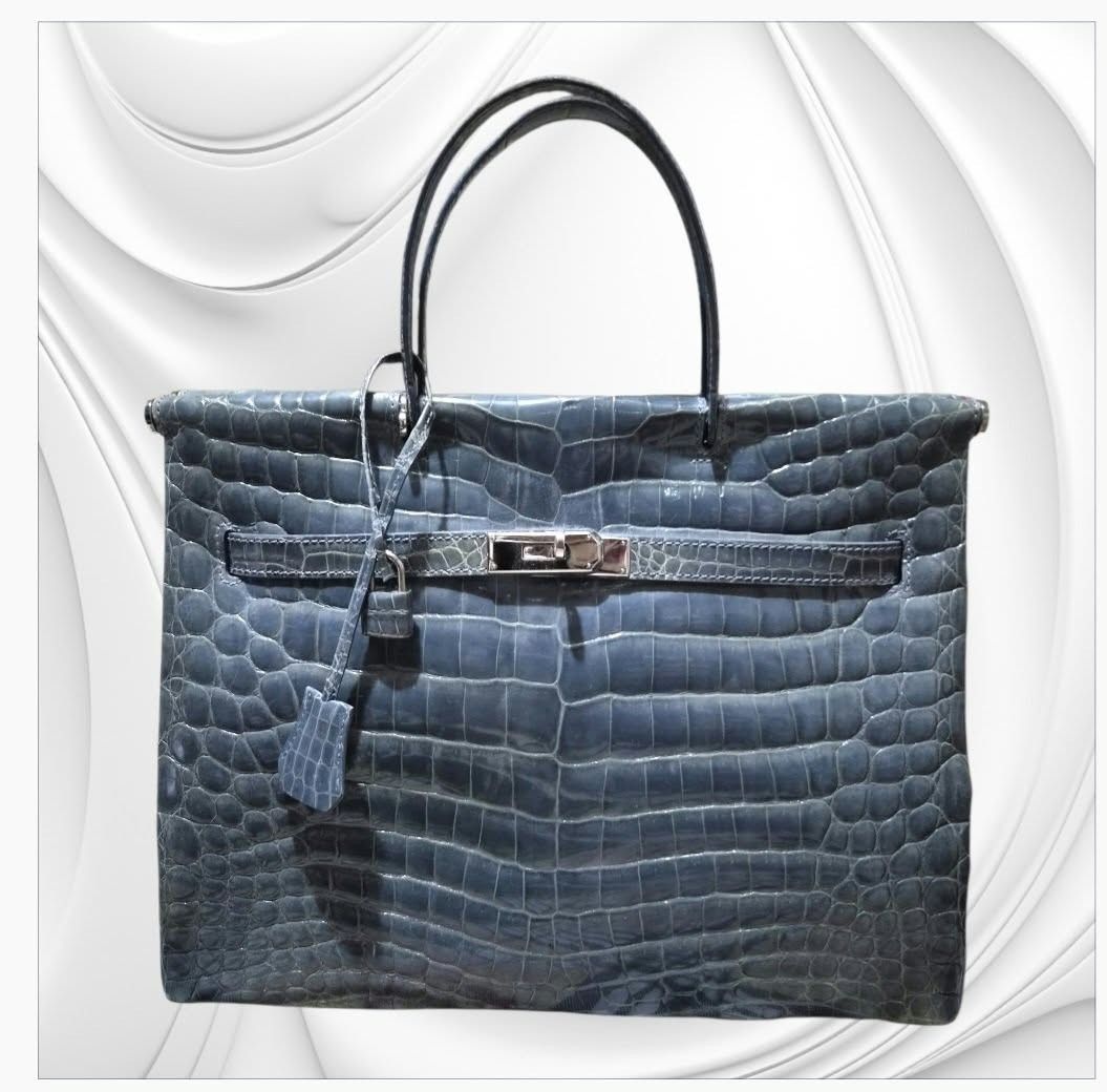 Blue Crocodile Embossed Leather Handbag With Strap And Lock (Category: Luxury Bags & Wallets) located in Paranaque City. Submitted by calm_youngstore7 (Listing ID 1468022902, Image 1). Description: A luxury blue crocodile leather handbag resembling an Hermès Birkin or Kelly 35 style in an exotic finish. • Material: Genuine or textured exotic leather featuring distinct scale patterns (such as Porosus or Niloticus crocodile/alligator). • Color: Dee