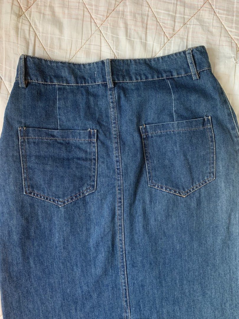 Blue Denim Midi Skirt with Back Slit (Category: Skirts) located in Bacoor. Submitted by krisery (Listing ID 1467949529, Image 3). Description: - Style: Mid-length denim skirt in a classic medium denim blue - Fit: High-waisted with front button closure and belt loops - Size: M on tag - Waist: 26 inch - Length: 30.5 inch - Fabric: Soft Denim (Lightweight/Non-stretch) - 2 Back and 2 Side Pockets - Condition: Excellent/No Damage - Not Faded color - G