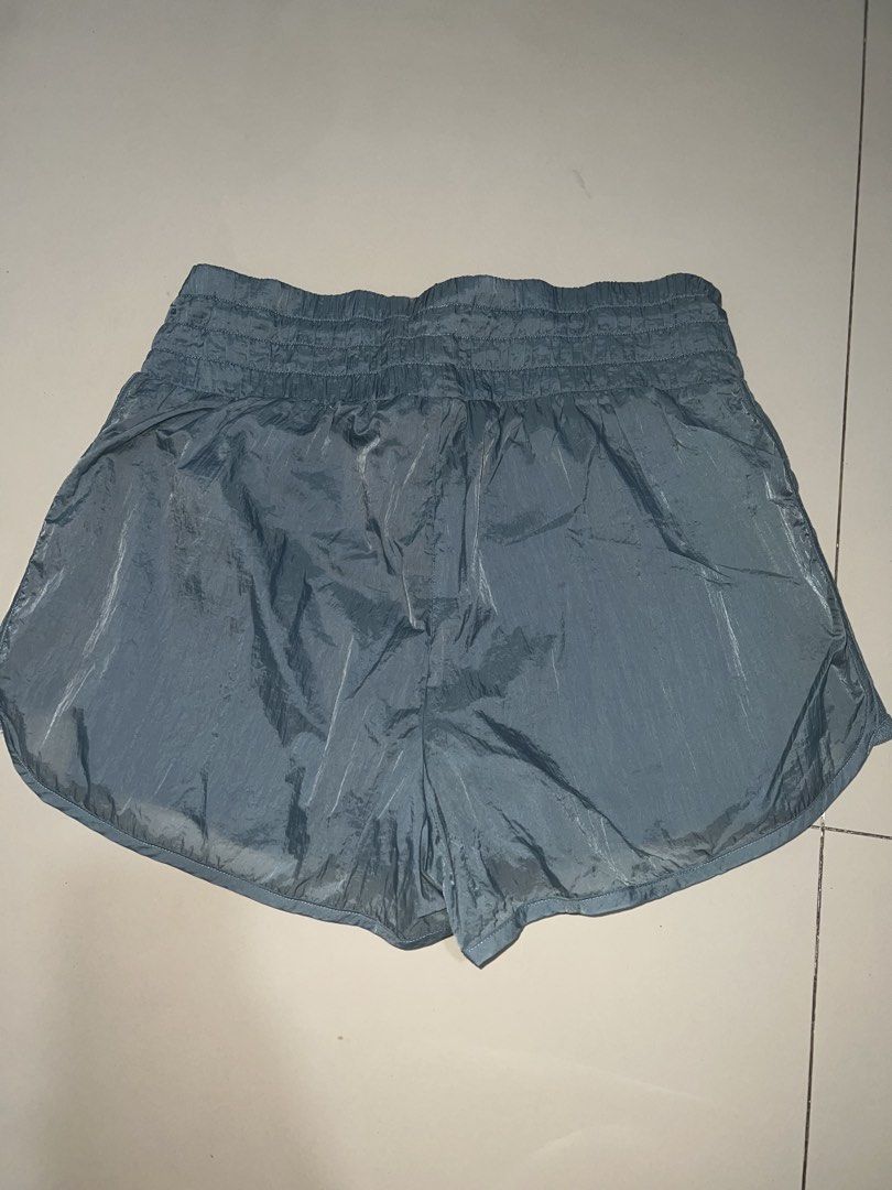 Blue Running Shorts built-in liner size M (Category: Activewear) located in Pasig City. Submitted by epitome.ph (Listing ID 1467938073, Image 2). Description: - Brand: Unknown - Size: Medium - Color: Dusty Blue - Material & Design: Crinkle texture fabric with breathable mesh side panels - Comfort & Fit: Elastic waistband with adjustable drawstring and built-in liner shorts for extra coverage - Origin: Made in Vietnam - Condition: Clean, excellent