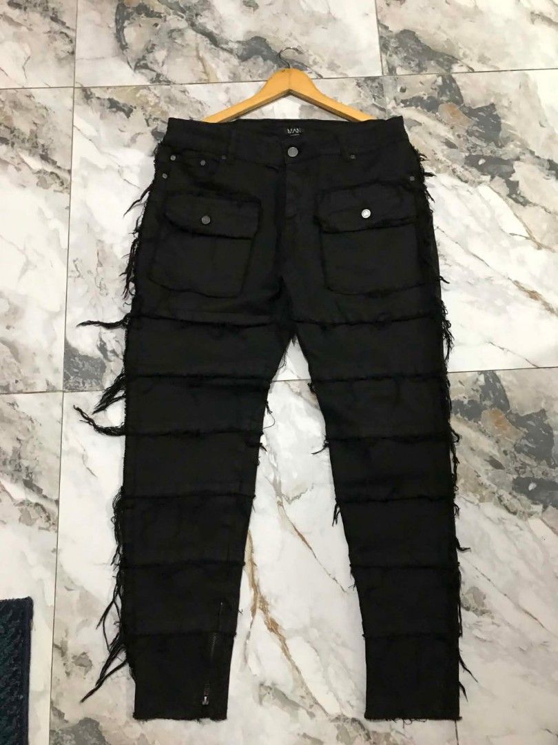 BoohooMAN Black Distress Cargo Pants Size 40 (Category: Jeans) located in Manila. Submitted by mikeee03 (Listing ID 1468007587, Image 3). Description: - Brand: BoohooMAN - Size: 40 - Color: Black - Details: Heavy distressing with fringe and layered panel construction - Pockets: Functional cargo pockets on front and back - Hem: Ankle zippers for an adjustable fit - Hardware: Dark metal hardware - Condition: Worn a few times, still in solid shape -