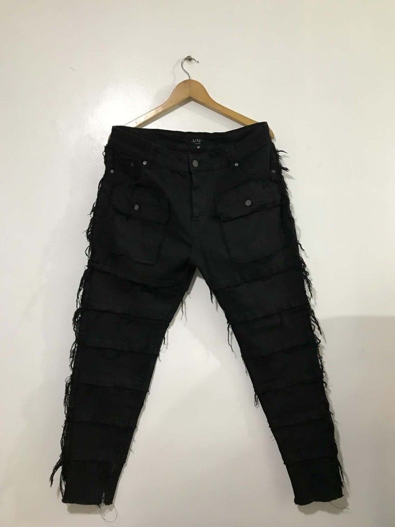 BoohooMAN Black Distress Cargo Pants Size 40 (Category: Jeans) located in Manila. Submitted by mikeee03 (Listing ID 1468007587, Image 2). Description: - Brand: BoohooMAN - Size: 40 - Color: Black - Details: Heavy distressing with fringe and layered panel construction - Pockets: Functional cargo pockets on front and back - Hem: Ankle zippers for an adjustable fit - Hardware: Dark metal hardware - Condition: Worn a few times, still in solid shape -