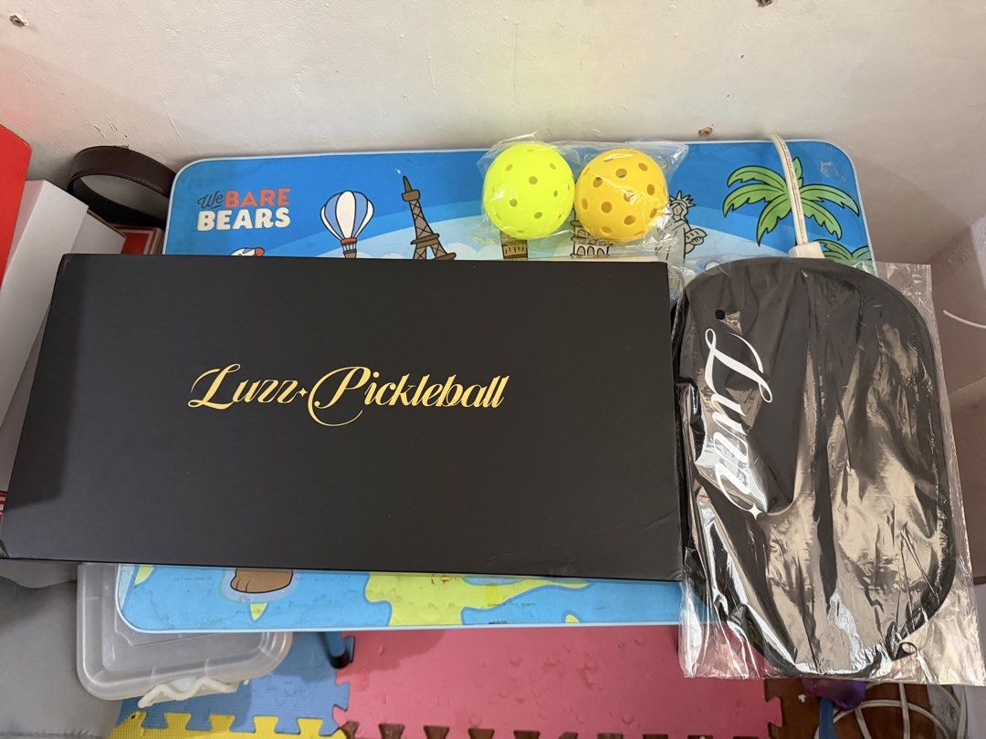 Brand New Luzz Glider 2026 (Category: Racket and Ball Sports) located in Taguig. Submitted by bumbayandsell (Listing ID 1467849444, Image 1). Description: - Brand: Luzz Glider 2026 Carbon Fiber T700 Pickleball Paddle - Colorway: Stylish Black and Pink - Condition: 100% Brand New, unused, and sealed in original packaging - Inclusions: Original branded presentation box, protective carrying case, and 2 yellow pickleball balls in factory plastic - Pe
