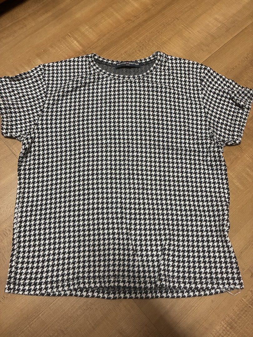 Brandy Melville Black White Houndstooth Tee Shirt (Category: Shirts) located in Quezon City. Submitted by habits.mnl (Listing ID 1467922979, Image 1). Description: - Brand: Brandy Melville - Style: Short sleeve tee with classic black and white houndstooth pattern - Fit: Casual fit with a round neckline - Material: Soft and comfortable knit fabric - Size: Small (tag at inner collar) - Condition: Excellent, pre-loved - Styling: Versatile piece, eas