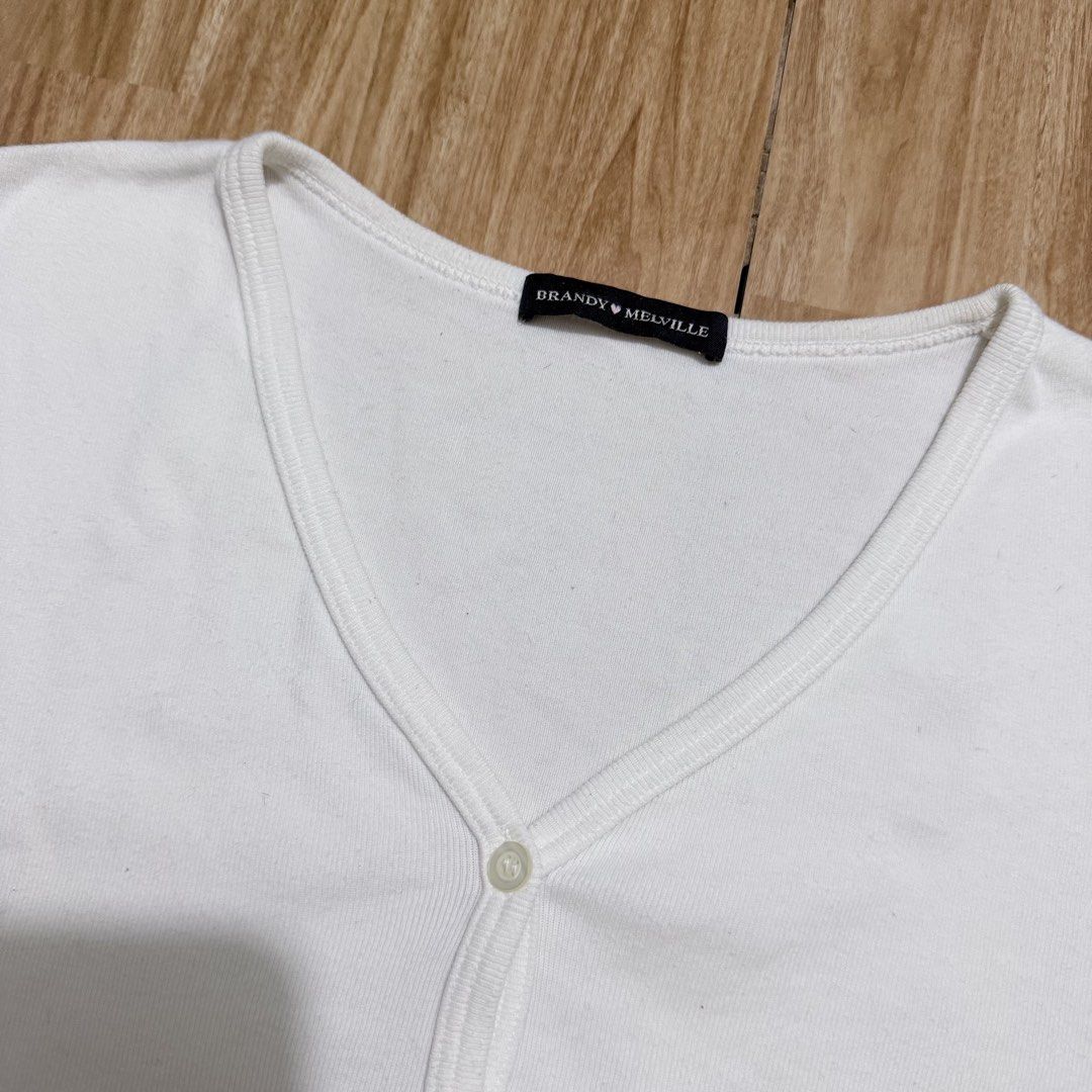 Brandy Melville White Button-Up Top (Category: Shirts) located in Angeles City. Submitted by gooddealsbytey (Listing ID 1468008762, Image 2). Description: Width: 19 | Length: 16.5.