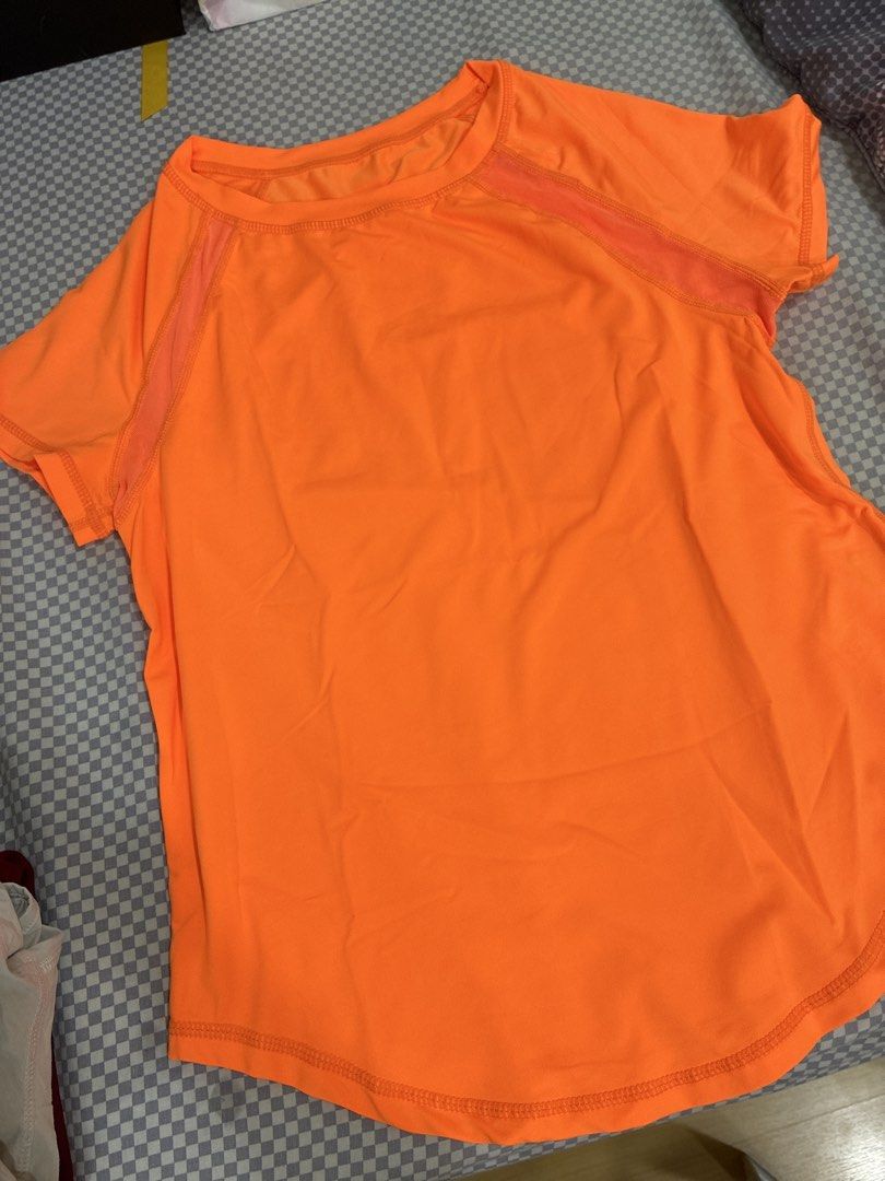 Bright Orange Athletic Short Sleeve Shirt (Category: Shirts) located in Manila. Submitted by shopmyclothesguys (Listing ID 1467923278, Image 1). Description: - Color: Bright orange - Style: Short sleeve activewear top with rounded bottom hem - Material: Lightweight, ideal for workouts and running - Feature: Mesh striping along shoulders and sleeves for extra airflow - Condition: Clean and vibrant look.