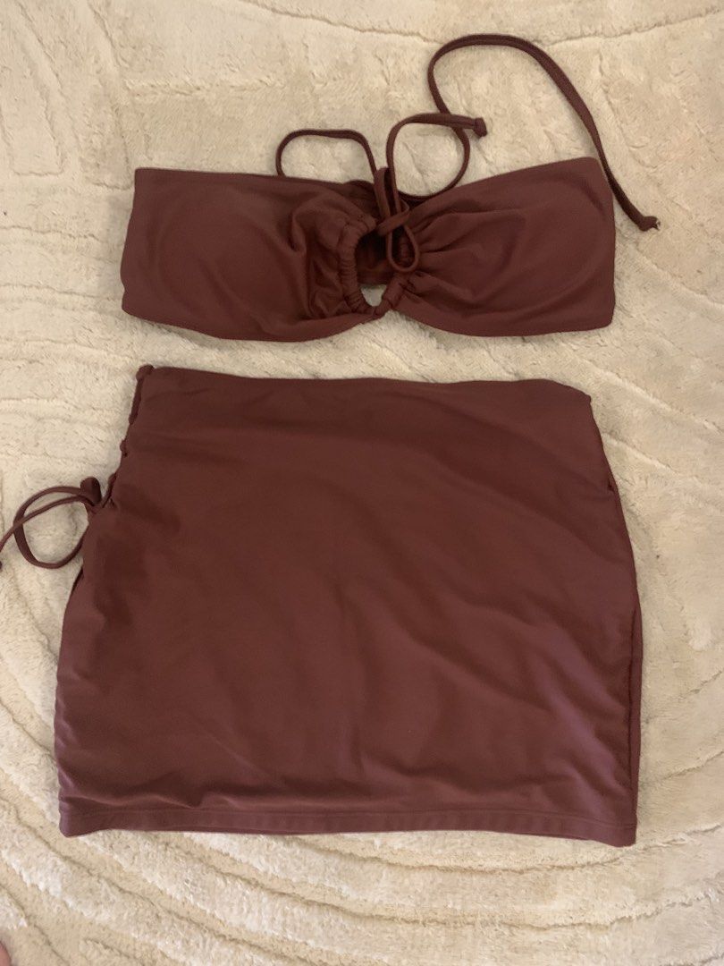Brown 3-Piece Bikini Set with Skirt Size S (Category: Bikinis & Swimsuits) located in Manila. Submitted by k8eee_ (Listing ID 1467897528, Image 2). Description: - Set includes: Strapless ring-detail top, matching bottoms, and a stylish side-tie skirt - Color: Rich deep chocolate brown - Size: Small (S) - Material: 80% polyamide, 20% elastane for a comfortable stretch - Ideal for: Beach trips, vacations, and pool days.