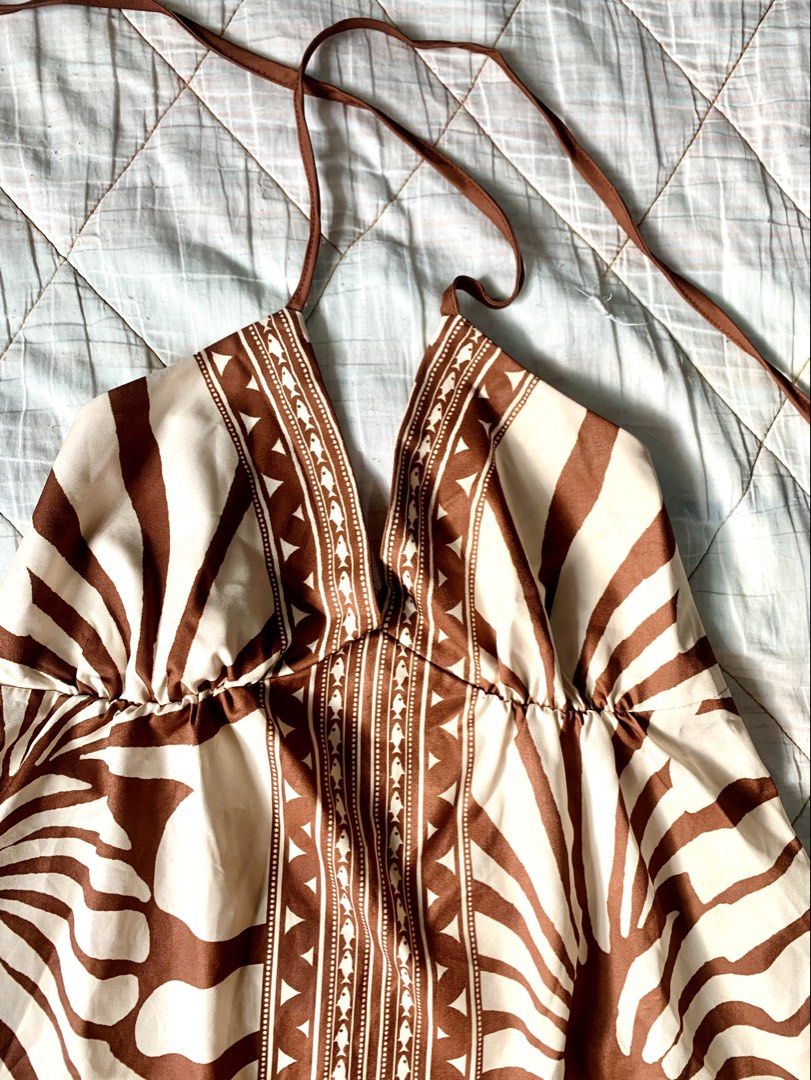Brown Boho Tropical Halter Sun Dress (Category: Dresses) located in Bacoor. Submitted by krisery (Listing ID 1467942673, Image 3). Description: - Style: Brown and cream sun dress with bold floral and tribal patterns - Design: Halter straps with adjustable tie neck and open back - Backless - Details: Eye-catching trim down the center front - Above the knee length - Fabric: Light, flowy, and breathable - Perfect for: Warm weather, vacations, and be