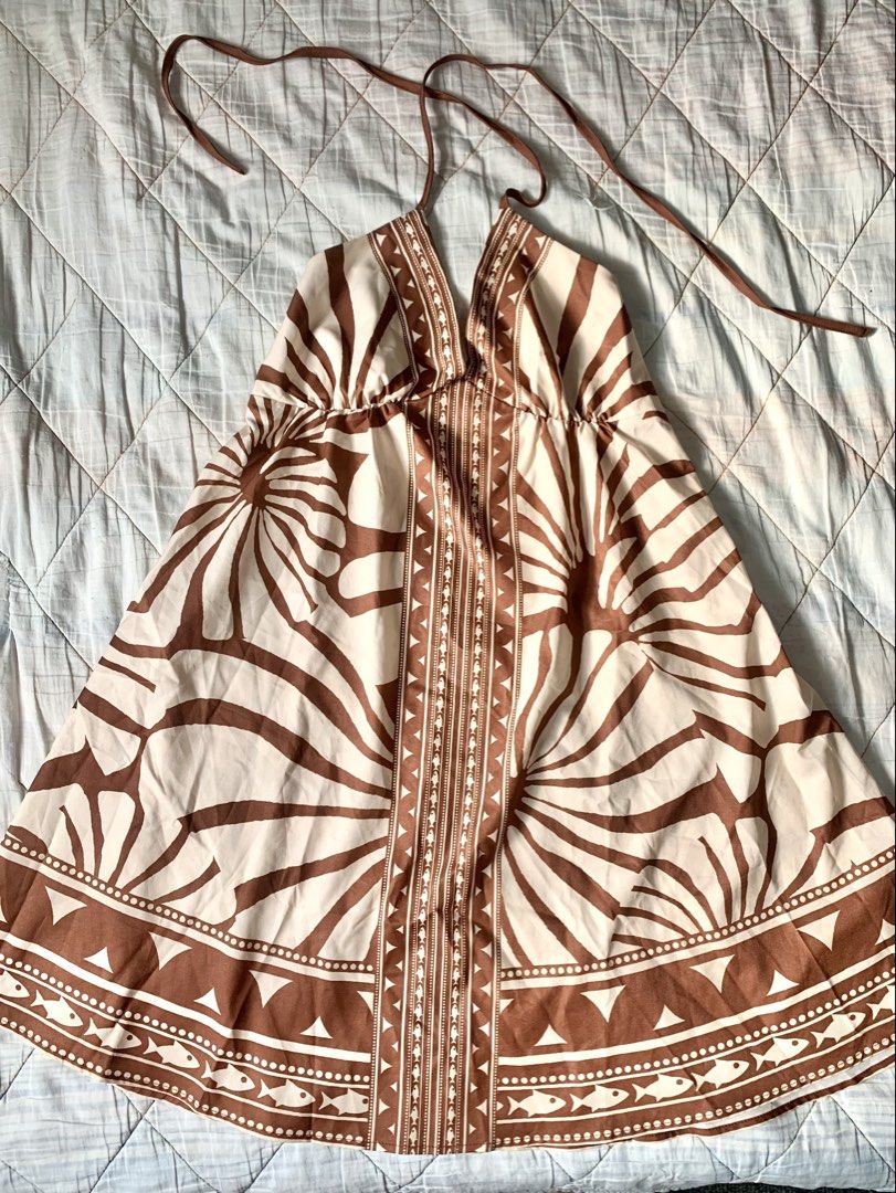 Brown Boho Tropical Halter Sun Dress (Category: Dresses) located in Bacoor. Submitted by krisery (Listing ID 1467942673, Image 2). Description: - Style: Brown and cream sun dress with bold floral and tribal patterns - Design: Halter straps with adjustable tie neck and open back - Backless - Details: Eye-catching trim down the center front - Above the knee length - Fabric: Light, flowy, and breathable - Perfect for: Warm weather, vacations, and be