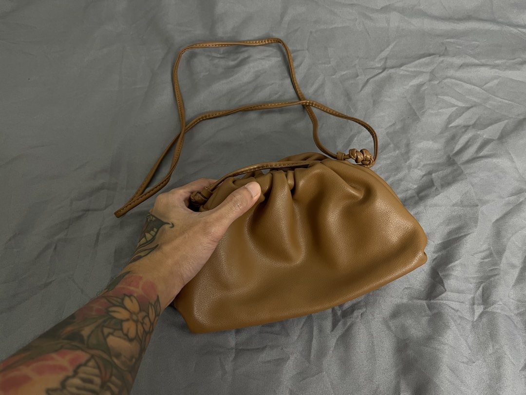 Brown Cloud Pouch Crossbody Bag (Category: Cross-body Bags) located in Imus. Submitted by graeyowl (Listing ID 1467951712, Image 2). Description: - Color: Tan - Material: Soft faux leather - Design: Gathered frame with magnetic closure - Strap: Thin strap for shoulder or crossbody wear - Interior: Clean and spacious for daily essentials - Condition: Some peeling on the inner frame trim from previous use - Style: Neat everyday accessory.