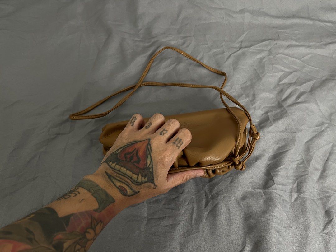 Brown Cloud Pouch Crossbody Bag (Category: Cross-body Bags) located in Imus. Submitted by graeyowl (Listing ID 1467951712, Image 3). Description: - Color: Tan - Material: Soft faux leather - Design: Gathered frame with magnetic closure - Strap: Thin strap for shoulder or crossbody wear - Interior: Clean and spacious for daily essentials - Condition: Some peeling on the inner frame trim from previous use - Style: Neat everyday accessory.