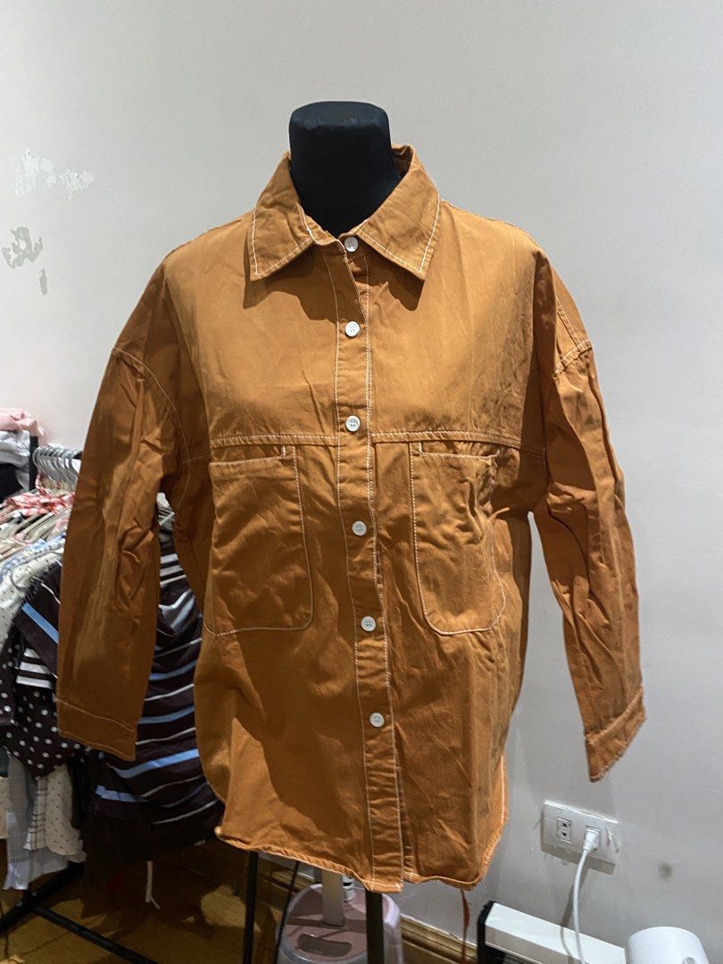 Brown Contrast Stitch Long Sleeve Button Up Shirt Jacket (Category: Coats, Jackets and Outerwear) located in Manila. Submitted by mpt99876 (Listing ID 1467992383, Image 1). Description: - Brown cotton-blend shirt jacket with contrast white stitching - Heavy canvas-like fabric, great for cooler days - Relaxed fit with drop shoulders and pointed collar - Front button closure and two chest pockets - Back yoke with a slight pleat detail for added com