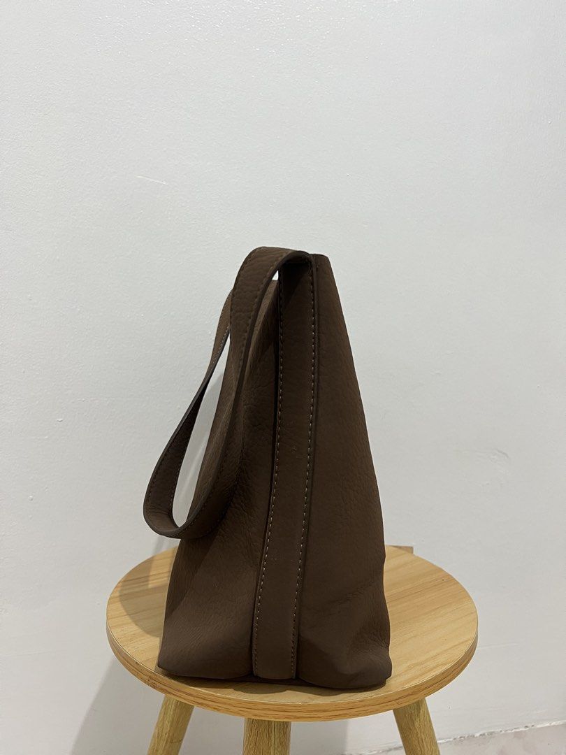 Brown Leather Shoulder Tote Bag (Category: Tote Bags) located in Manila. Submitted by bosetph (Listing ID 1467962544, Image 2). Description: - Color: Neutral dark brown - Material: Genuine leather with clean stitching - Design: Open top with a spacious unlined interior - Straps: Thick and comfortable for daily wear - Capacity: Easily fits all your daily essentials - Style: Simple, minimal, and versatile.