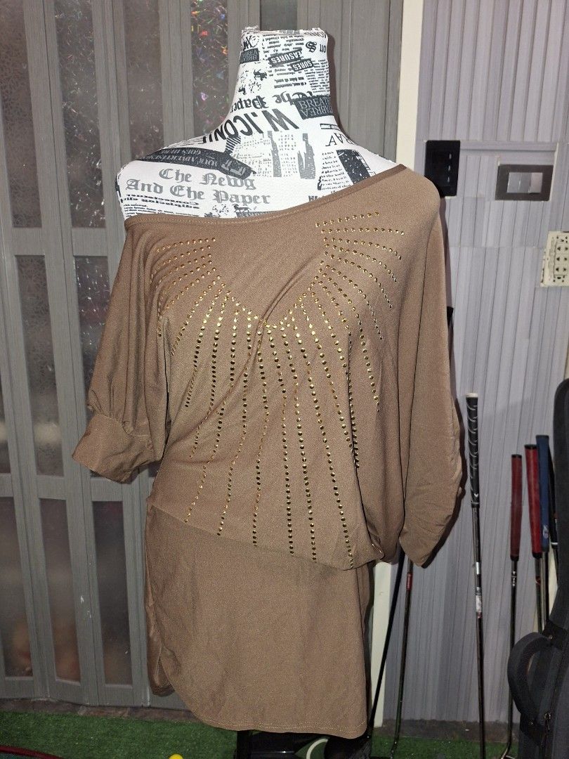 Brown Top With Gold Stud Details (Category: Blouses) located in Manila. Submitted by mialiurshop (Listing ID 1467902240, Image 1). Description: - Color: Brown - Design: Asymmetrical neckline with gold studs in a ray pattern - Fit: Relaxed body with half sleeves - Fabric: Soft and stretchy for comfort - Styling: Great to pair with dark jeans for a casual night out.