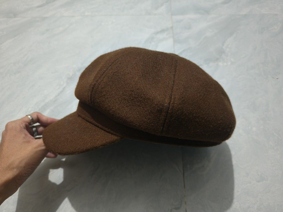 Brown Wool Newsboy Hat (Category: Caps & Hats) located in Paranaque City. Submitted by vicibaltazar (Listing ID 1467883054, Image 2). Description: - Style: Classic octagonal panel design with a stiff front brim - Material: Soft textured woolen fabric to keep you warm on cooler days - Versatility: Perfect complement for vintage outfits, streetwear, or casual weekend looks - Fit: Comfortable fit for average head sizes - Color: Brown.