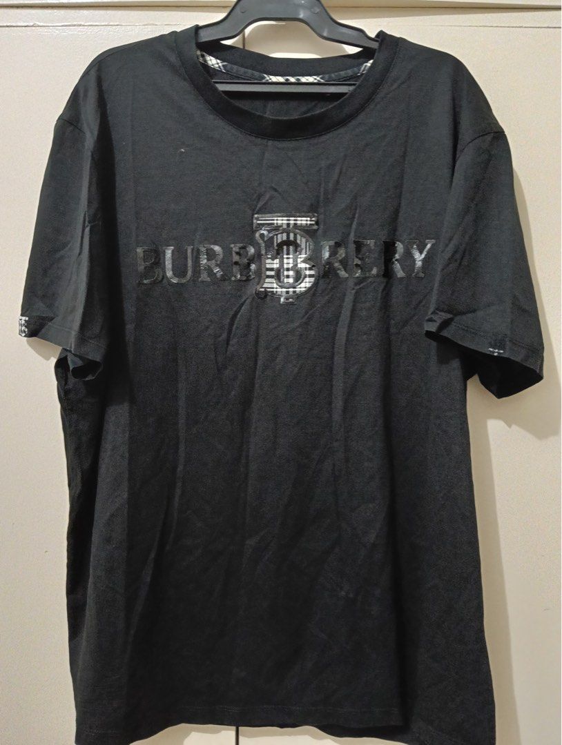 Burberry Black T-Shirt (Category: Shirts) located in Manila. Submitted by goddesssy (Listing ID 1467839912, Image 1). Description: - Brand: Burberry - Item: Black T-shirt with large chest logo - Size: L - Origin: Made in Vietnam - Neckline: Classic crew neck - Condition: Excellent / Ready to wear - Style: Versatile, easy to style for casual everyday looks.