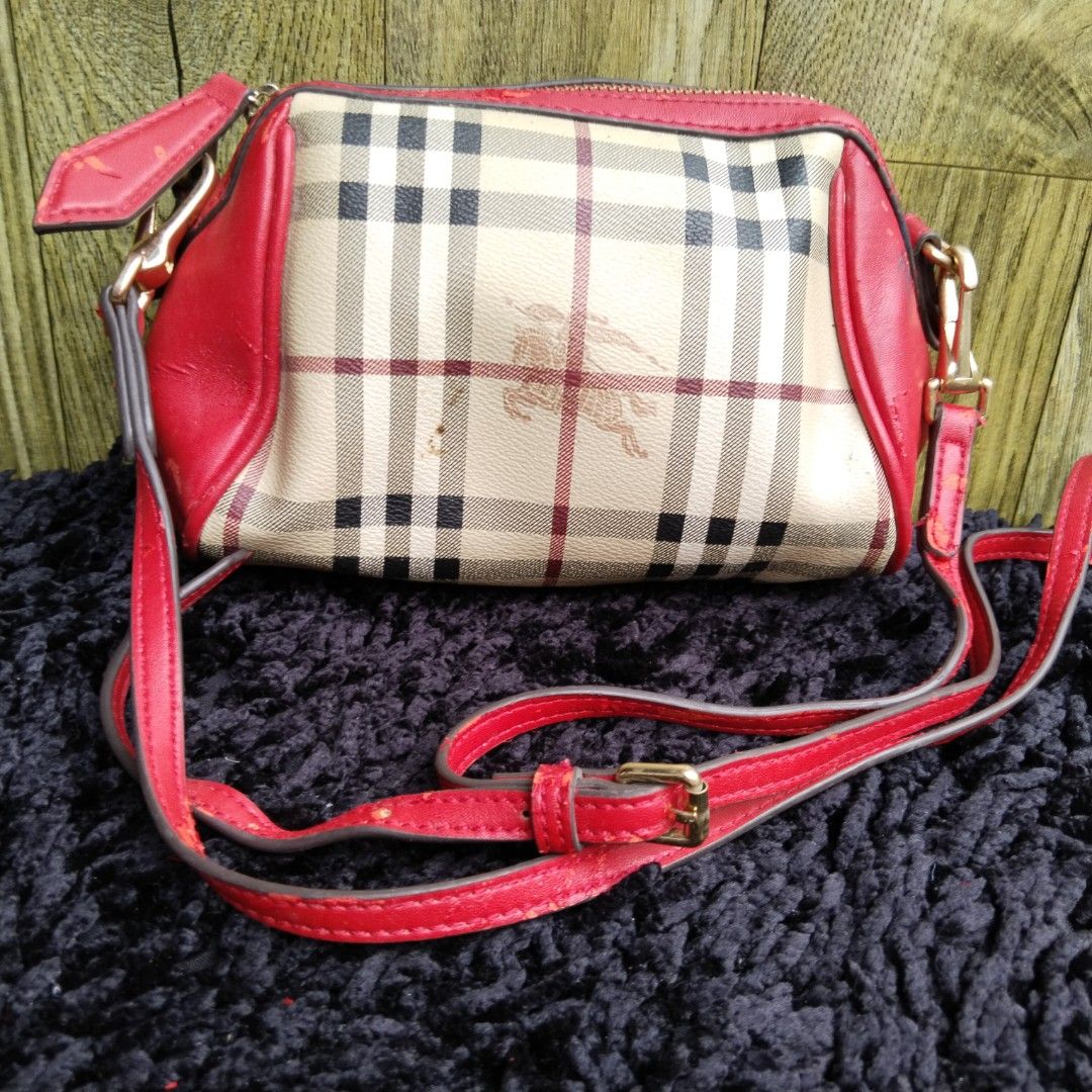 Burberry Nova Check Crossbody Bag Red (Category: Luxury Bags & Wallets) located in Lubao. Submitted by dione_closet503 (Listing ID 1467894862, Image 1). Description: - Authentic Burberry crossbody bag in classic Nova Check canvas - Eye-catching bright red leather trim and adjustable shoulder strap - Secure top zipper closure with gold-tone hardware - Features the signature embossed equestrian knight logo - Compact size, perfect for daily essentia