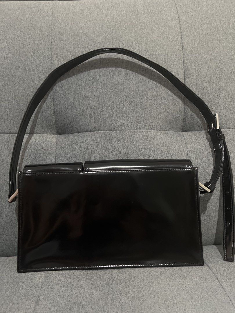 By Far Black Patent Leather Shoulder Bag (Category: Luxury Bags & Wallets) located in Las Pinas. Submitted by erenrosc (Listing ID 1467914848, Image 2). Description: By Far shoulder bag in black patent leather. Silver twist-lock closures on the front flaps. Includes two exterior front compartments. Adjustable shoulder strap. Neutral lining inside with embossed brand patch. Minor scuffs on the hardware from normal use. End of strap has minor flaws