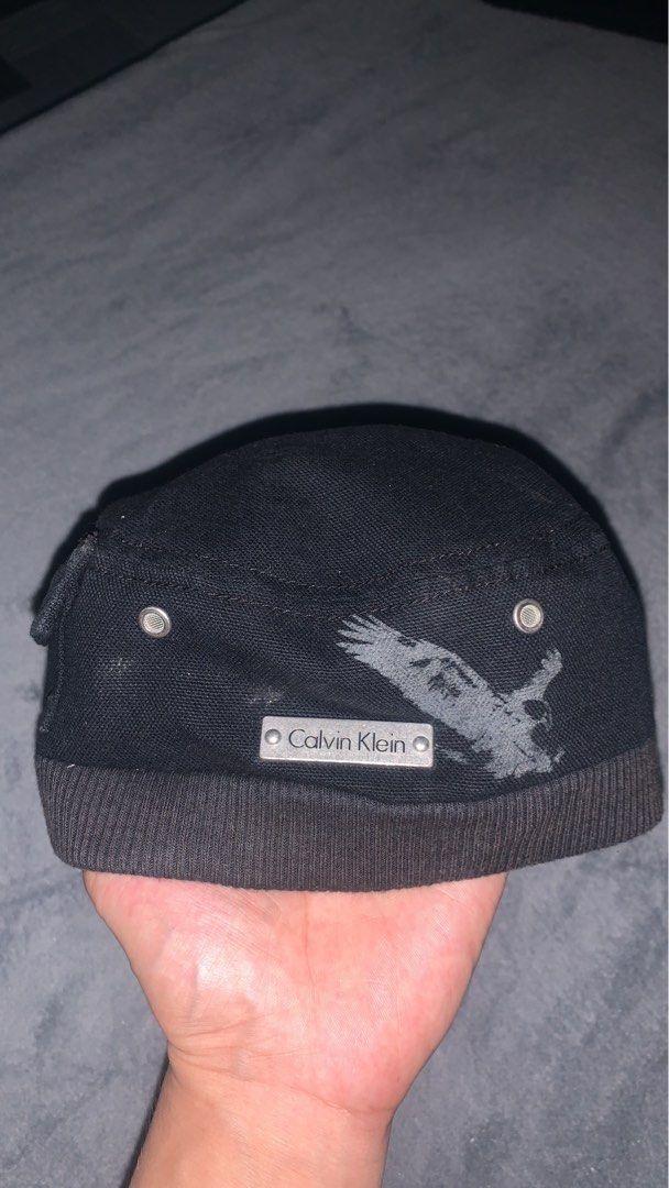 Calvin Klein Black Vintage Cadet Cap (Category: Caps & Hats) located in Angeles City. Submitted by kj772c_ (Listing ID 1468054298, Image 3). Description: - Brand: Calvin Klein - Style: Cadet Cap - Color: Black - Size: One Size - Material: 100% Cotton (Made in Taiwan) - Design details: Embroidered CK logo patch on the side, metal CK plate with graphic on the back - Ventilation: Metallic eyelets for breathability - Comfort: Ribbed band at the base 