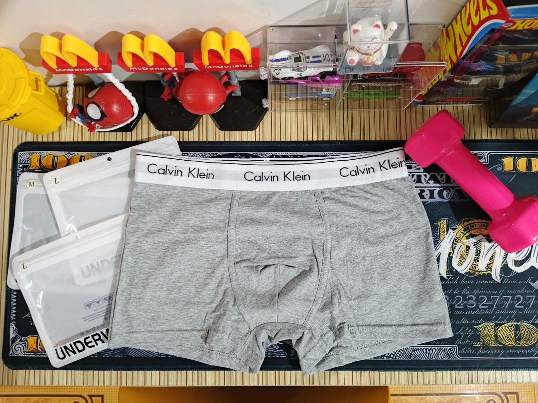 Calvin Klein Men's Boxer Briefs Bundle (Category: Underwear) located in Taytay. Submitted by roseannblente2016 (Listing ID 1467906835, Image 3). Description: - Authentic Calvin Klein boxer - Classic colors: Black, White, and Grey - Premium cotton - Iconic branded elastic waistband on each pair - Clean stitching and soft fabric texture - Includes 3 individual frosted zip-lock packaging bags - Available in sizes M and L - Grab the set today!.