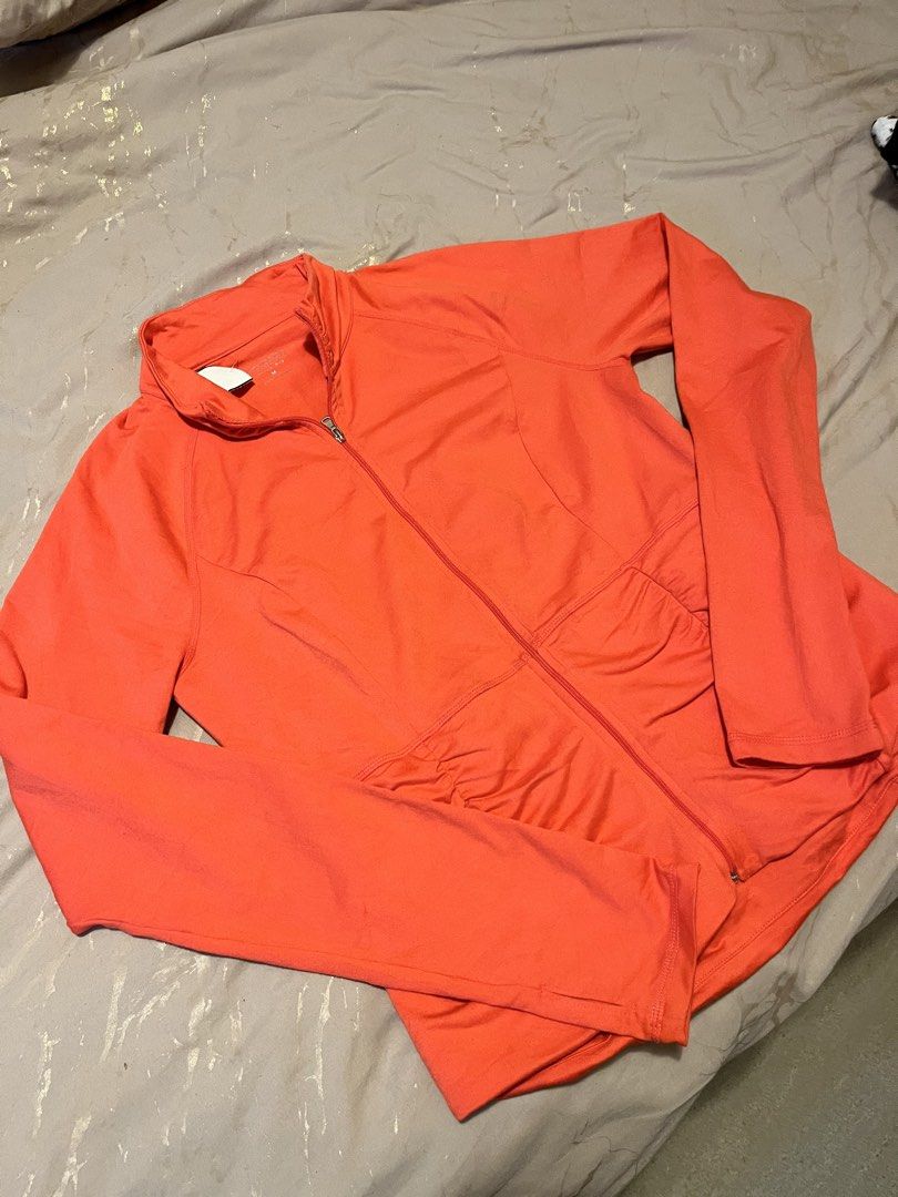 Calvin Klein Performance Orange Zip-Up Active Jacket Size M (Category: Coats, Jackets and Outerwear) located in Cebu City. Submitted by harborclothing29 (Listing ID 1467936198, Image 1). Description: Bright orange Calvin Klein Performance active jacket in size Medium. Features a full front zipper, high collar, ruched pockets, and stretchy fabric. Perfect for workouts and casual wear..